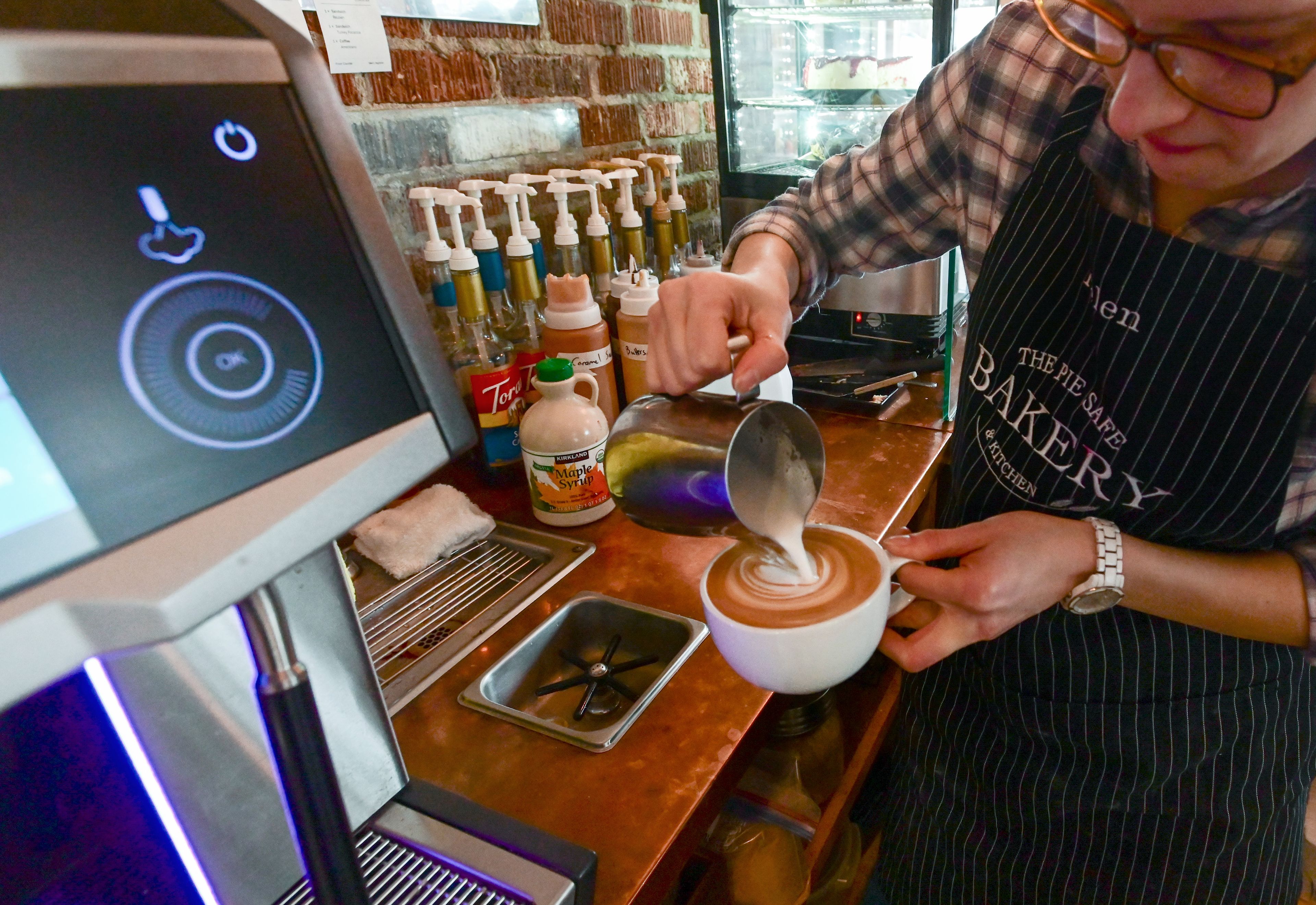 Floor manager Helen Pressly prepares a latte at The Pie Safe Bakery in Deary on Wednesday.