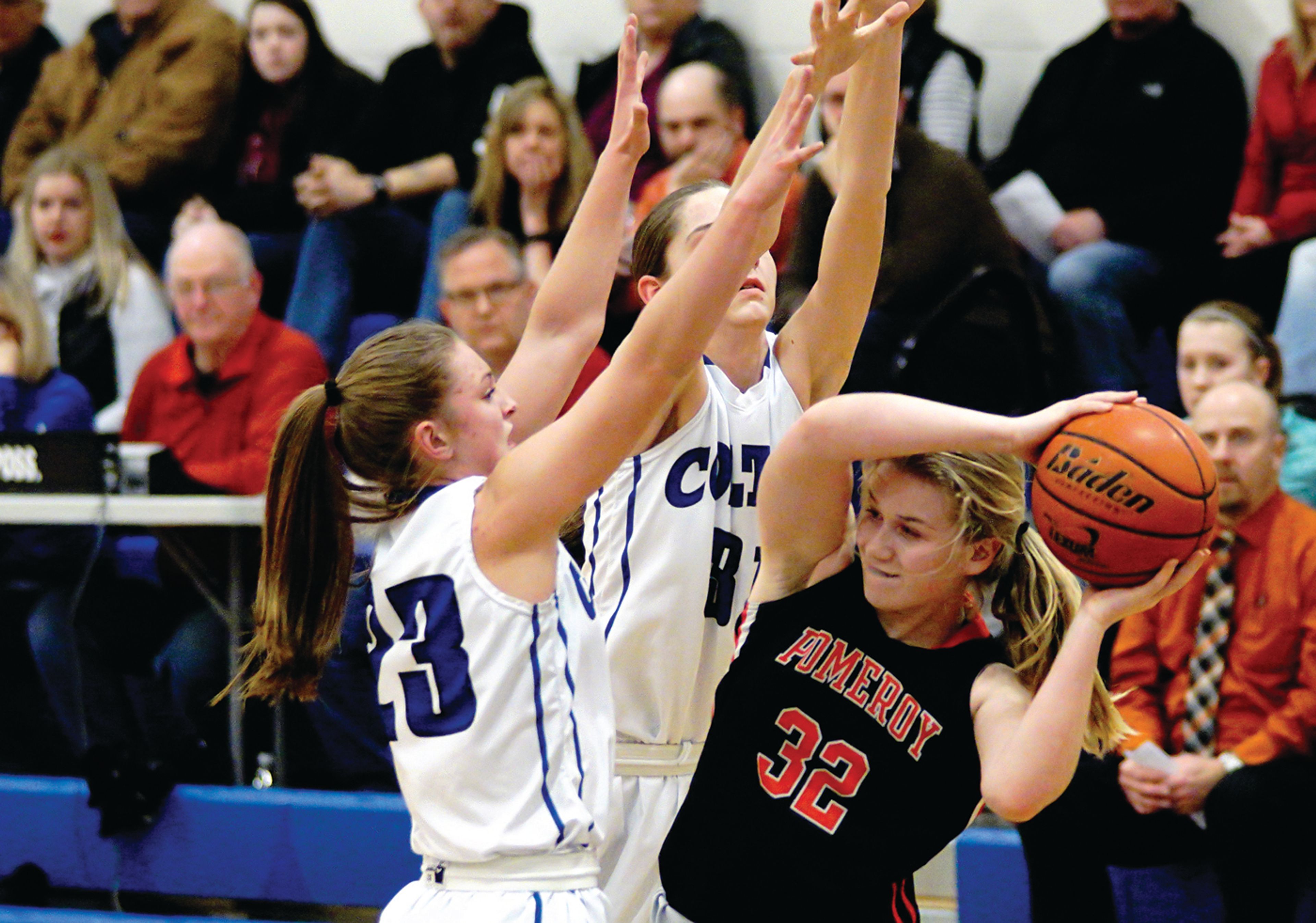 Pomeroy's Emma Severs (32) tries to find a way out of a doubleteam by Colton's Jordan Moehrle (23) and Emily Schultheis on Friday night at Colton.