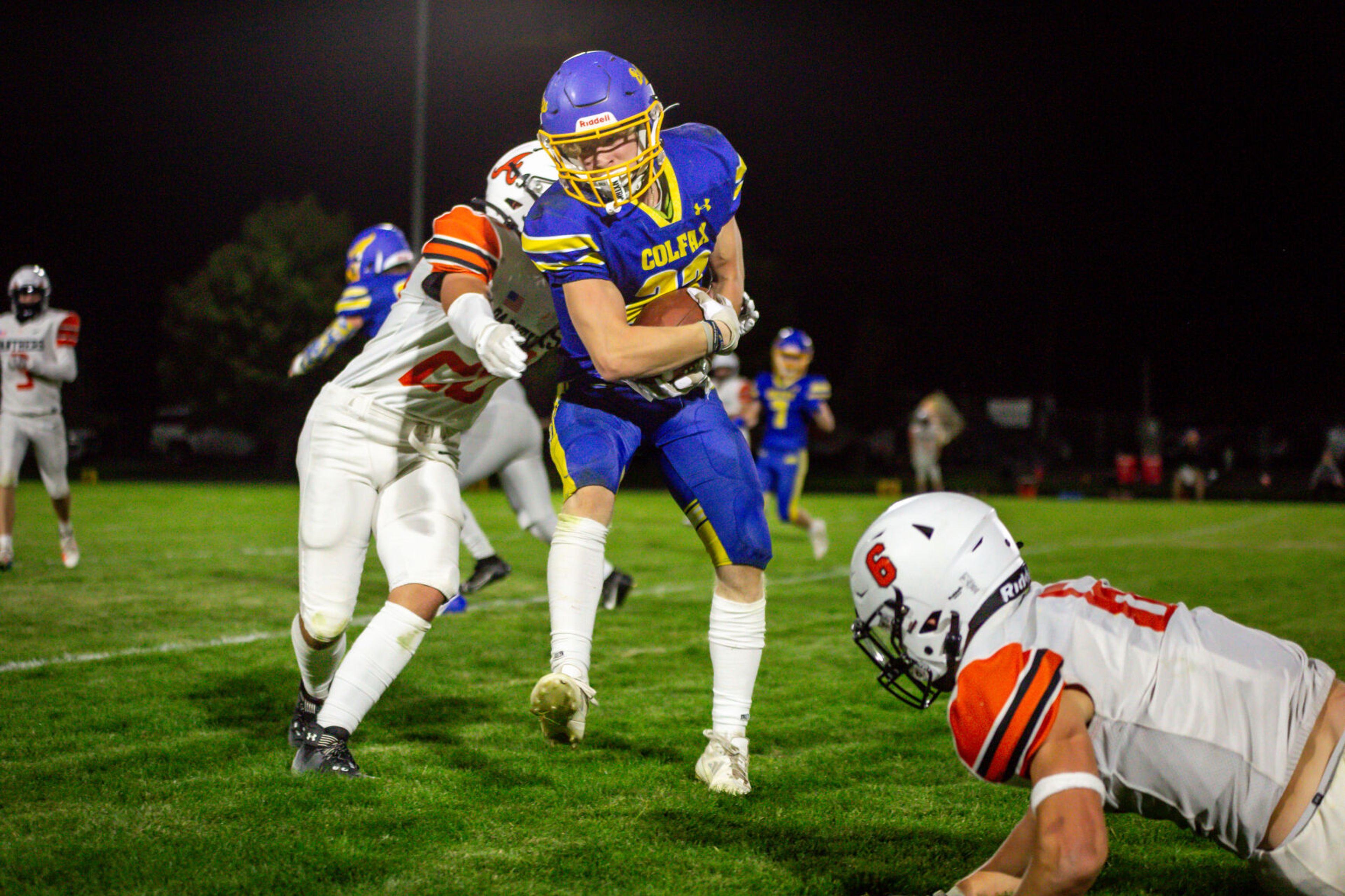 Colfax senior wide receiver Zach Cooper works to gain yards during a game against Asotin on Friday, Sept. 20, in Colfax.