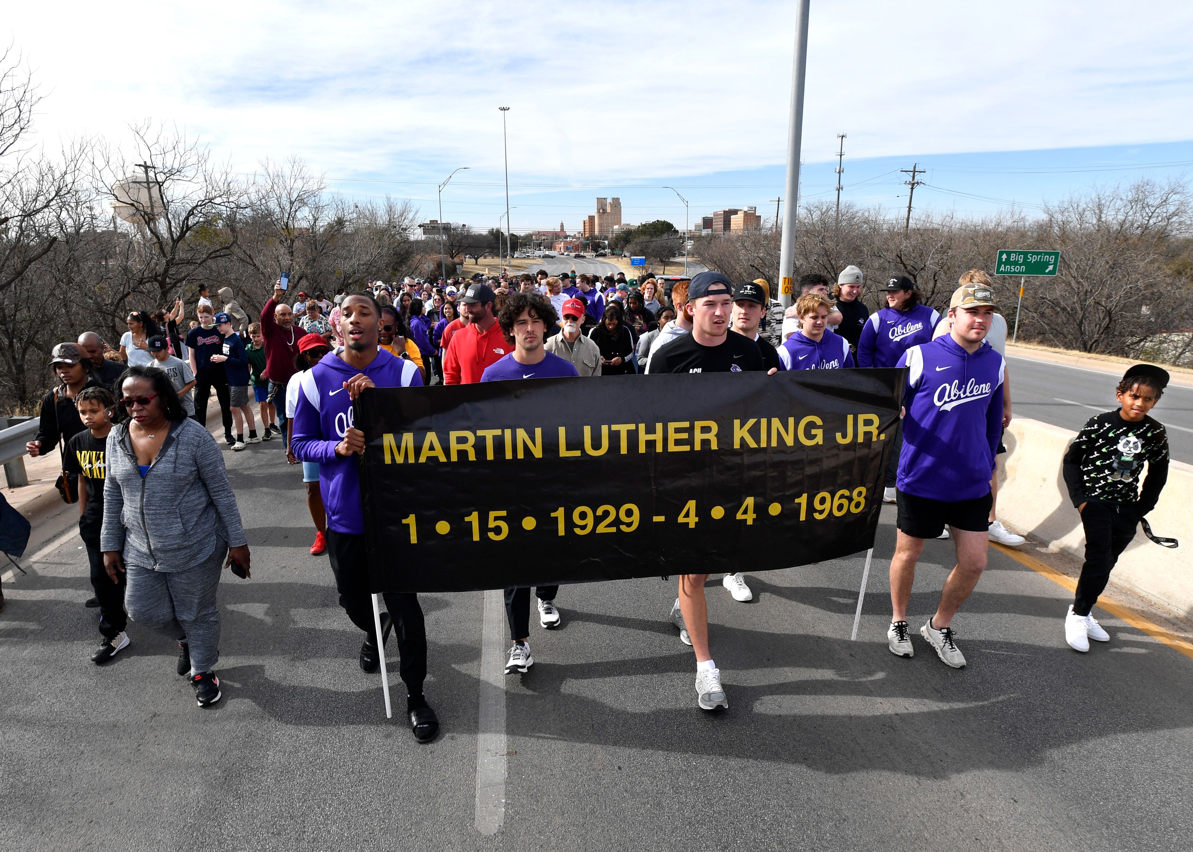 Students from Abilene Christian University and other community members lead the march honoring Martin Luther King Jr., over the bridge which bears the civil rights icon's name, in Abilene, Texas, Monday, Jan. 16, 2023. (Ronald W. Erdrich/The Abilene Reporter-News via AP)