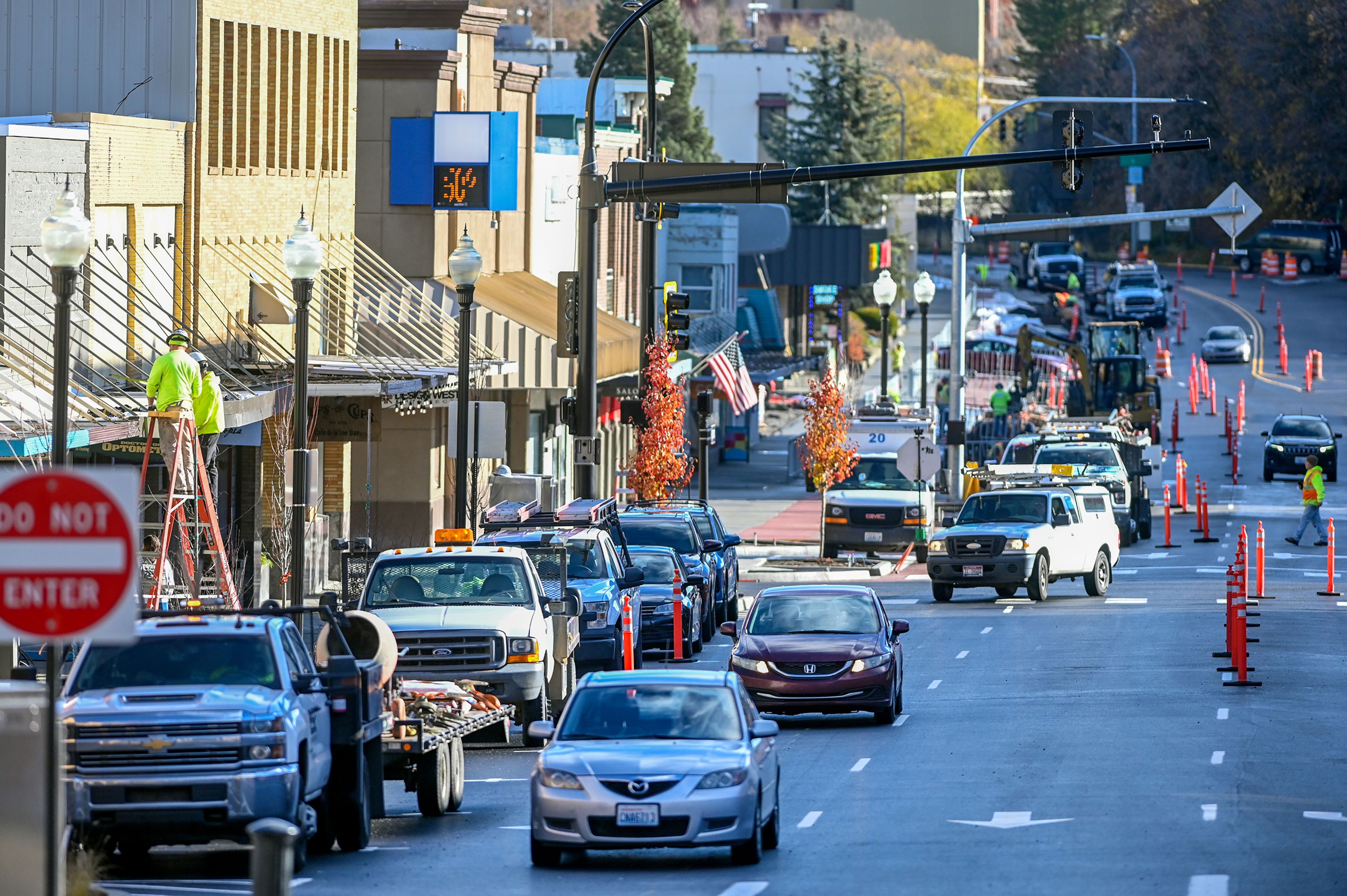 Cars move down Main Street after the road partially reopened to traffic Thursday in Pullman. Work continues in areas of the street, with construction expected to finish in late November.