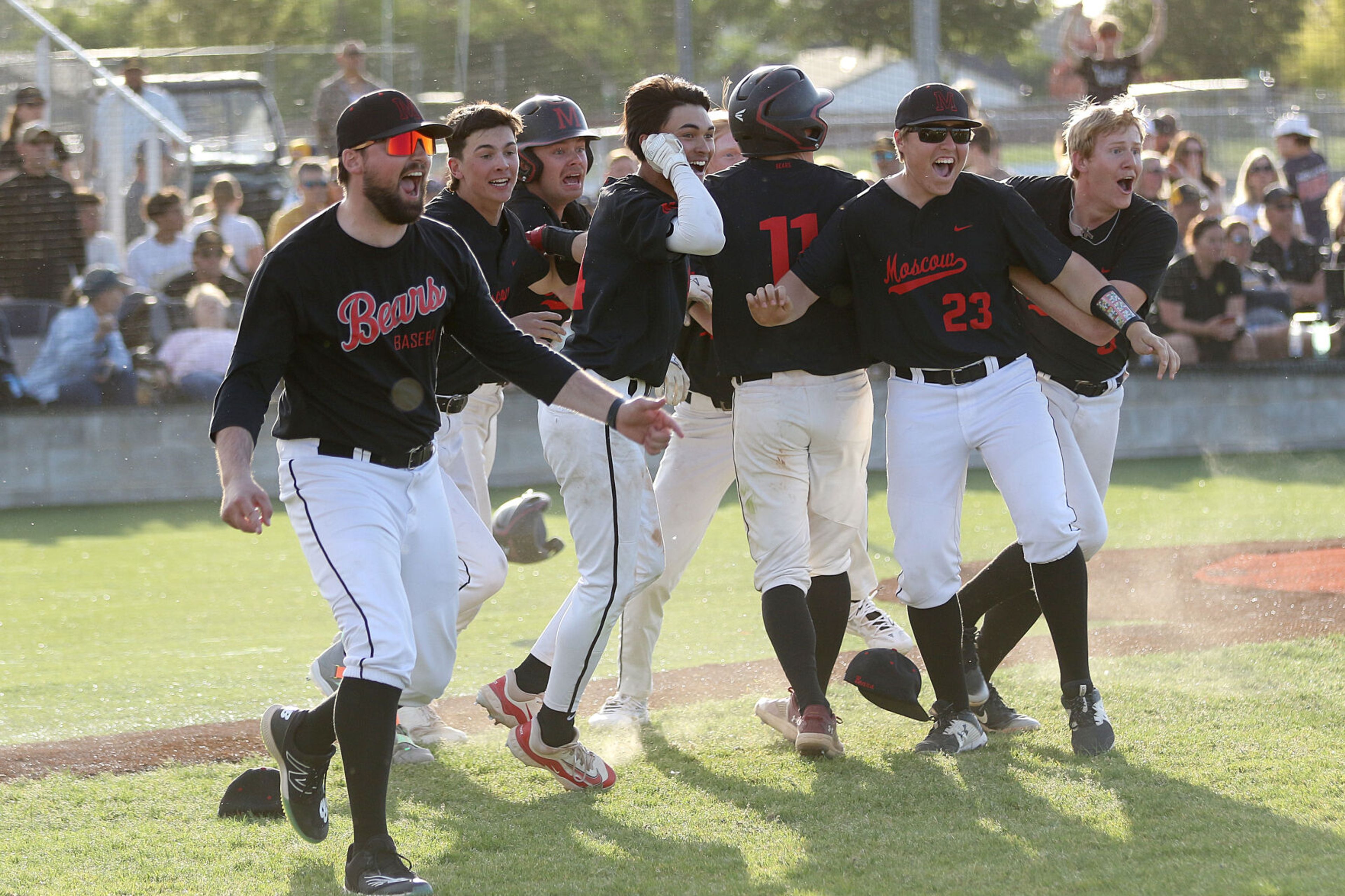 The Moscow baseball team celebrates after a walk-off win in the Idaho Class 4A state championship game on Saturday at Vallivue high School in Caldwell, Idaho.