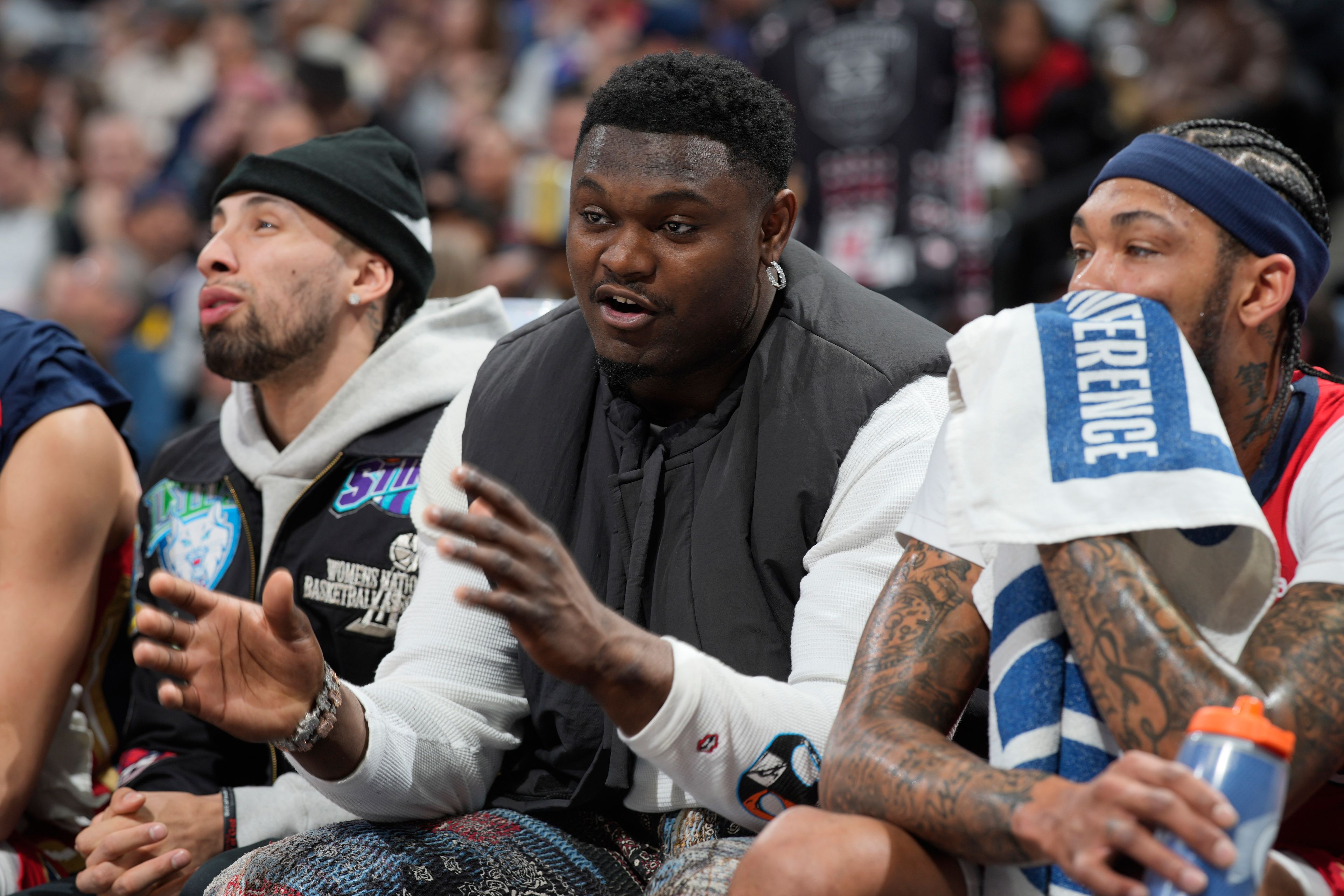 New Orleans Pelicans forward Zion Williamson, center, sits on the bench between guard Jose Alvarado, left, and forward Brandon Ingram during the first half of the team's NBA basketball game against the Denver Nuggets on Thursday, March 30, 2023, in Denver. (AP Photo/David Zalubowski)