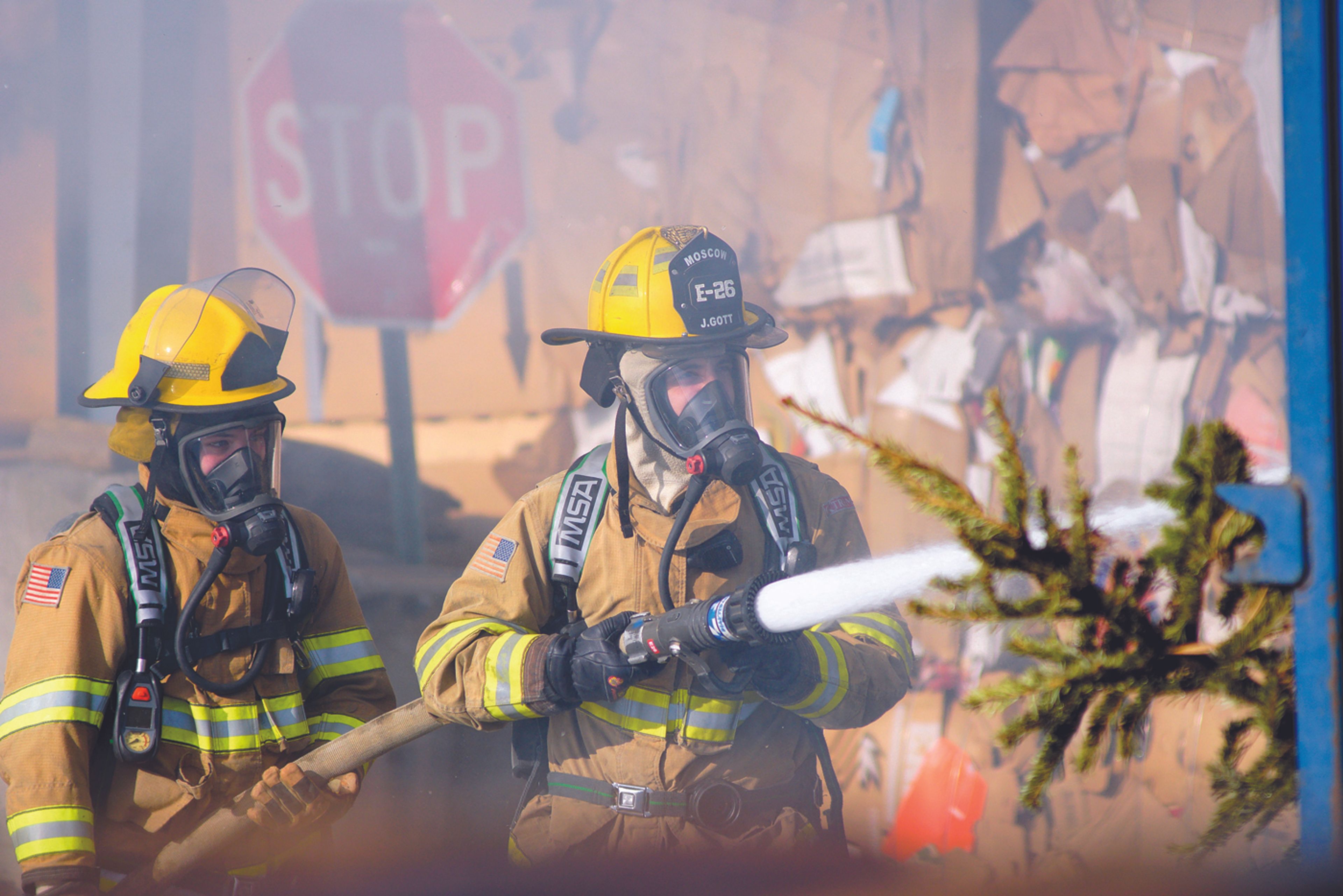 Moscow firefighters work to extinguish a fire in a dumpster full of Christmas trees Jan. 12 at the Moscow Recycling Center. The cause of the fire is unknown.