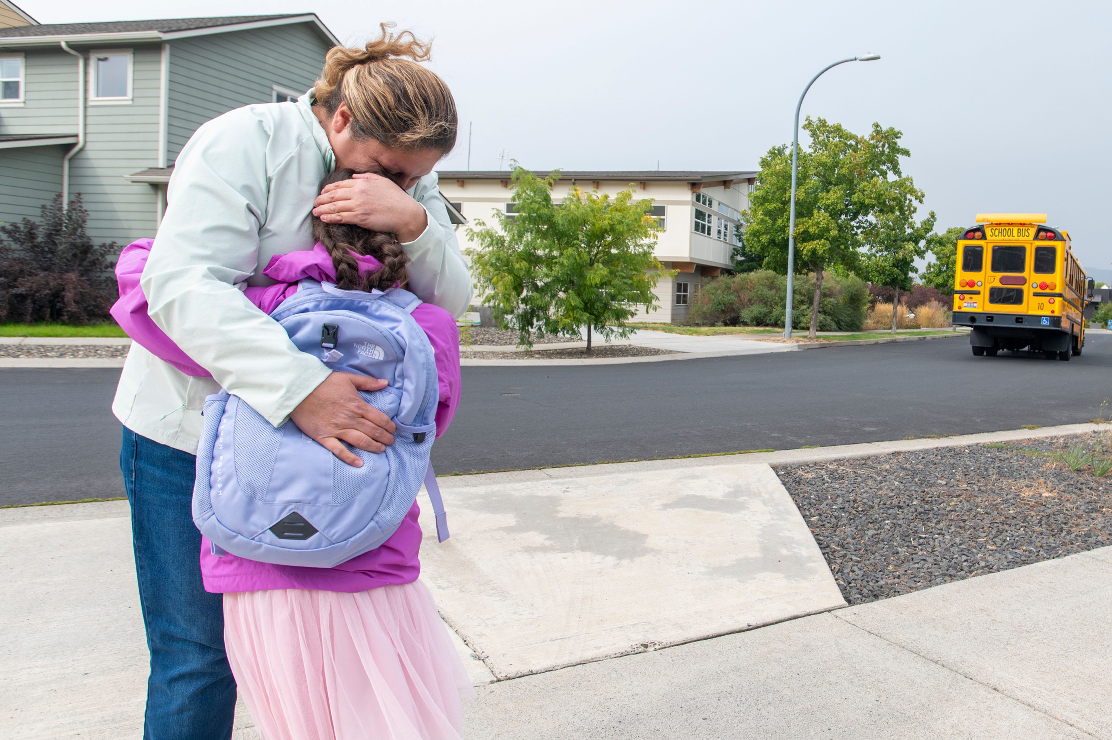 Laren Paul, 8, hugs her mother, Gia, outside their Moscow home Thursday.