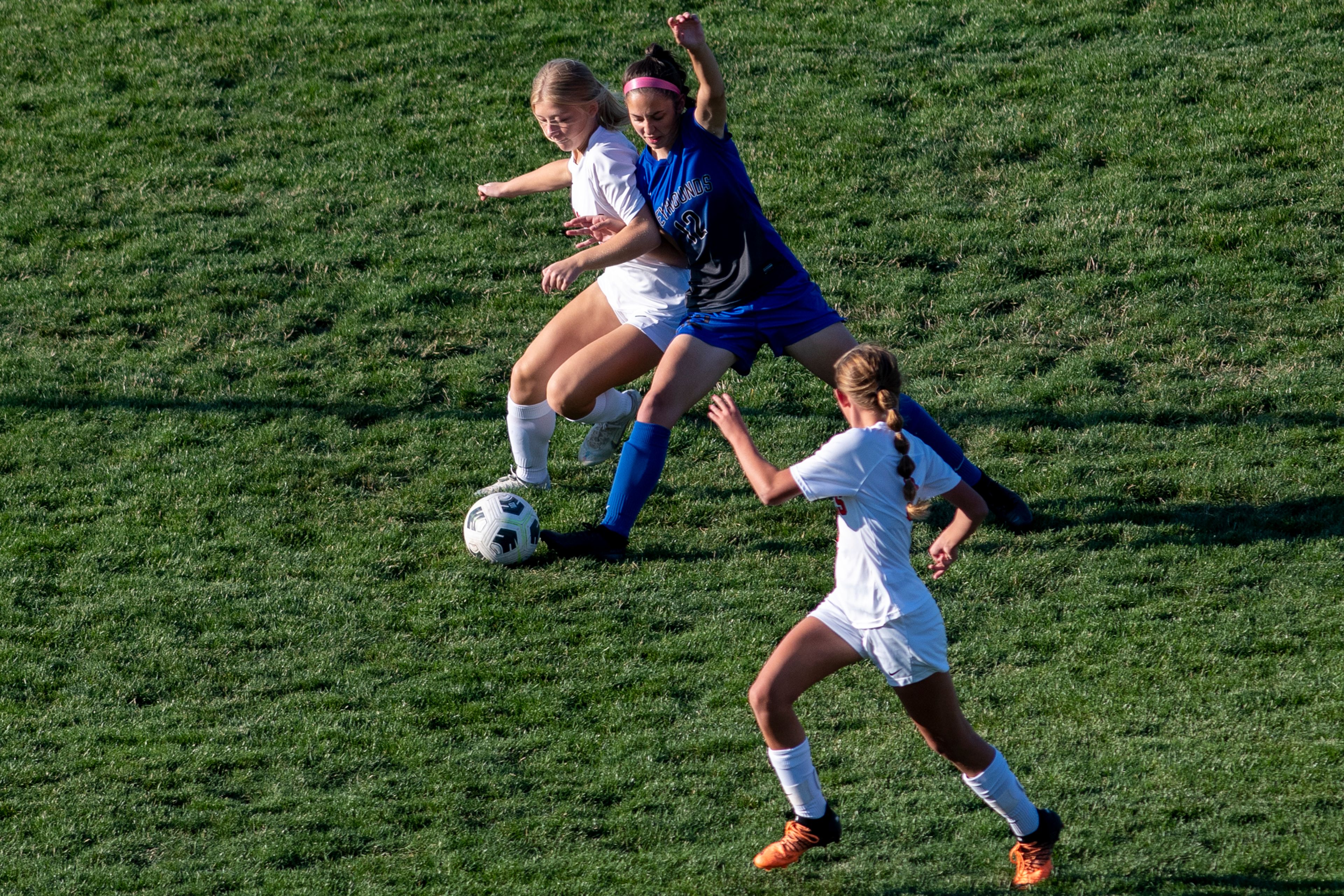 Pullman’s Jennabee Harris (12) fights for possession of the ball against West Valley’s Claire Busse (9) during a Class 2A Greater Spokane League game at Pullman High School on Tuesday.