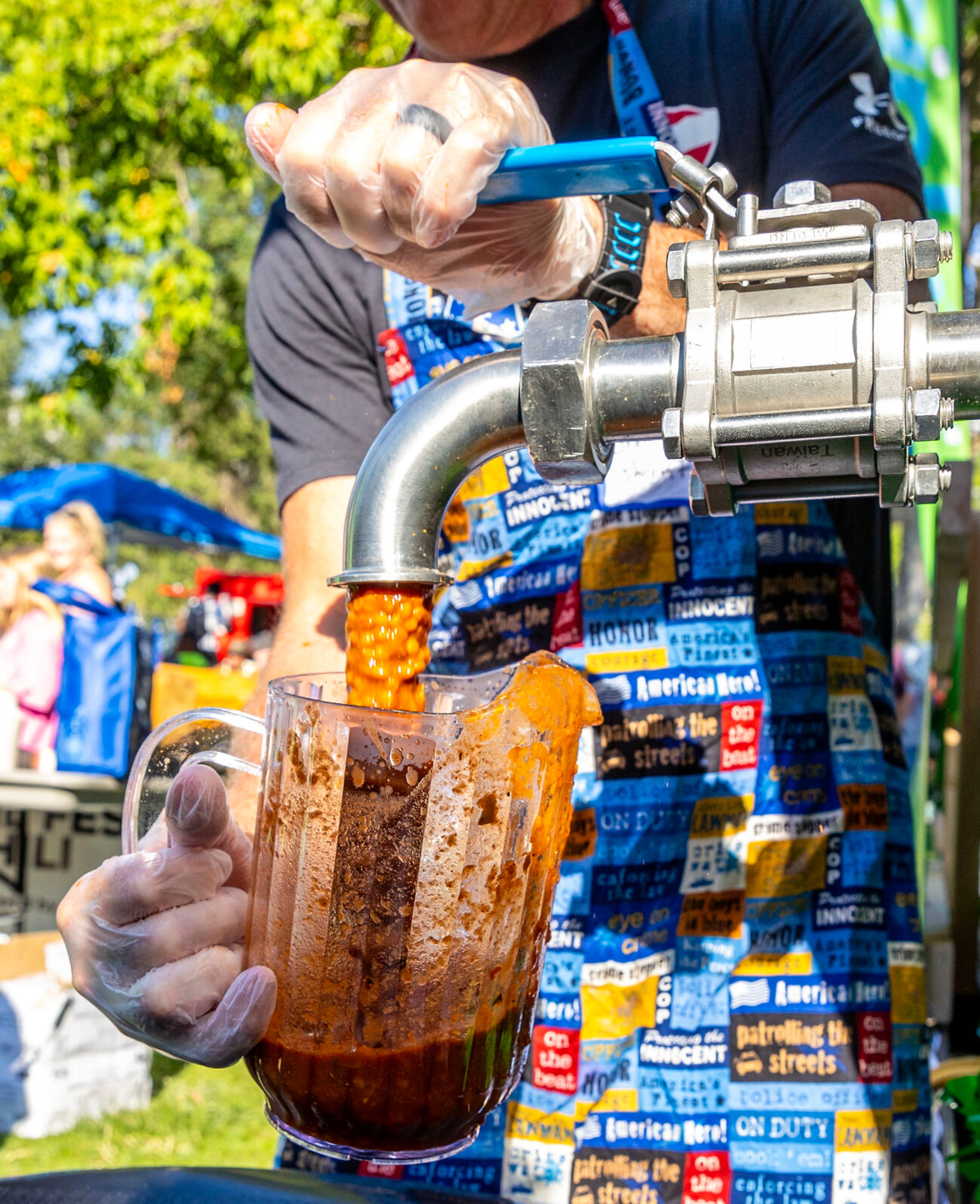 A jug is filled up with Lentil chili Saturday at Lentil fest in Reaney Park in Pullman.