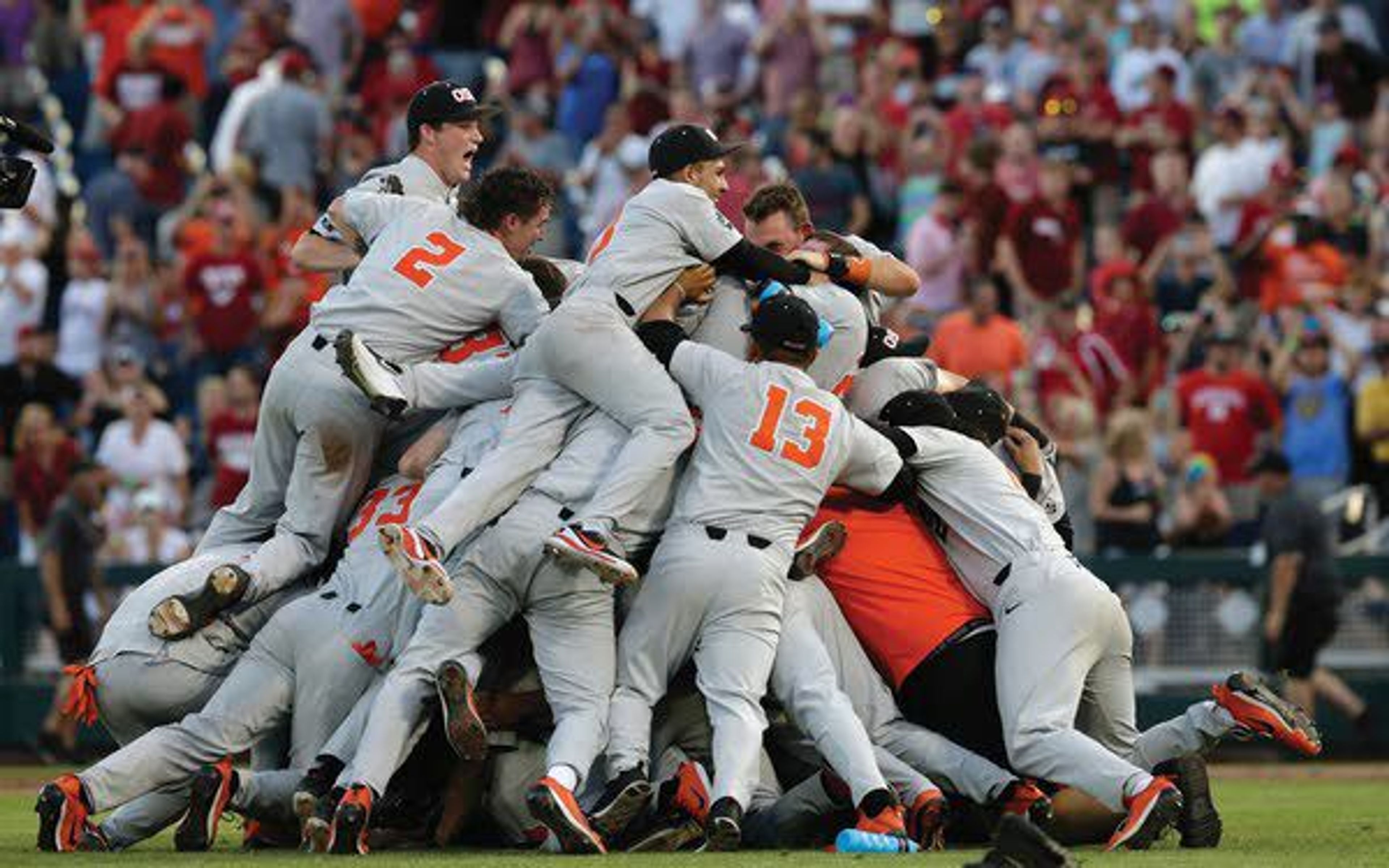 Oregon State players celebrate after they beat Arkansas 5-0 in Game 3 to win the NCAA College World Series finals Thursday in Omaha, Neb.