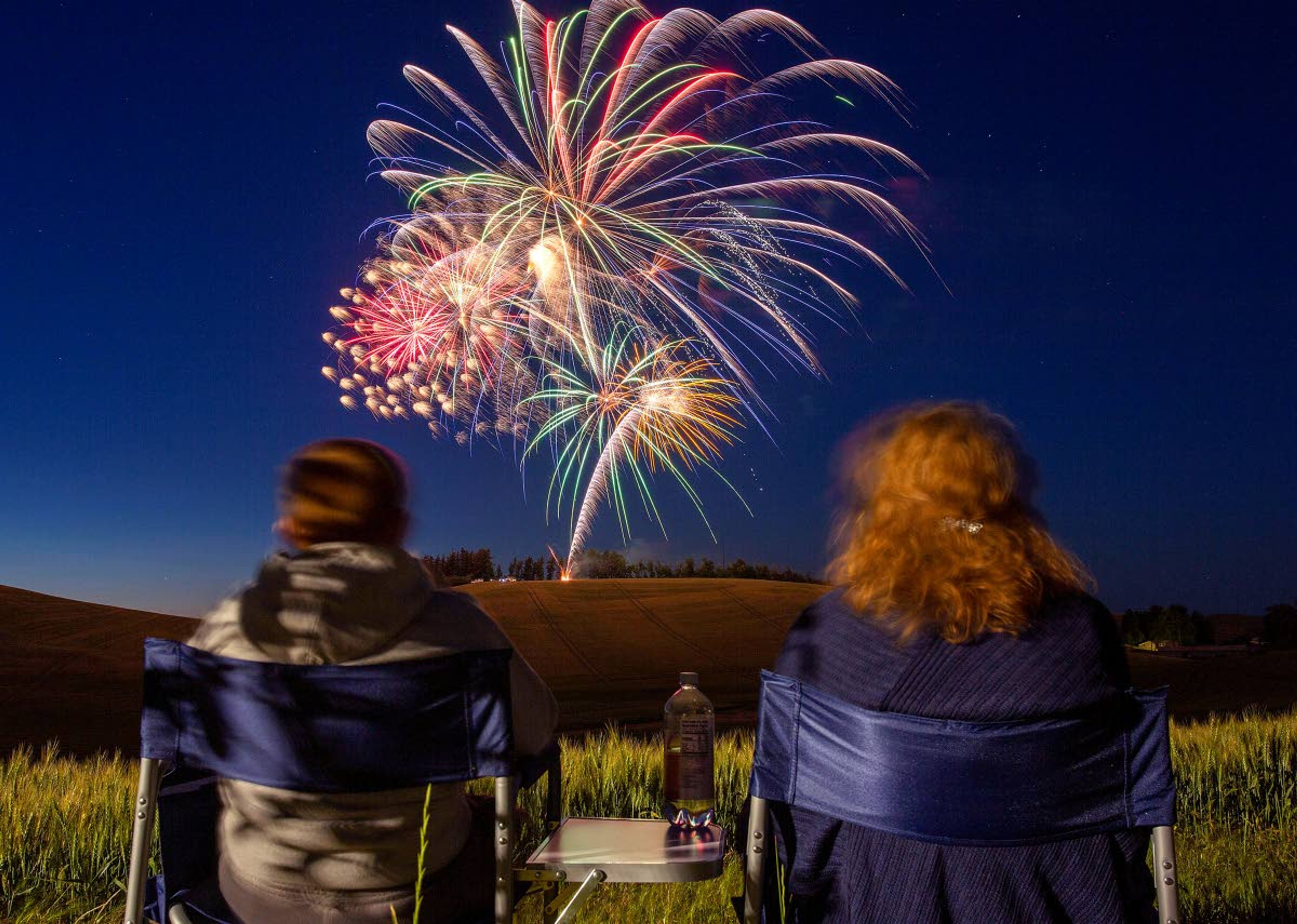 Residents watch the Pullman's fireworks display while sitting in folding chairs along Northwest Terre View Drive in this 2020 file photo.