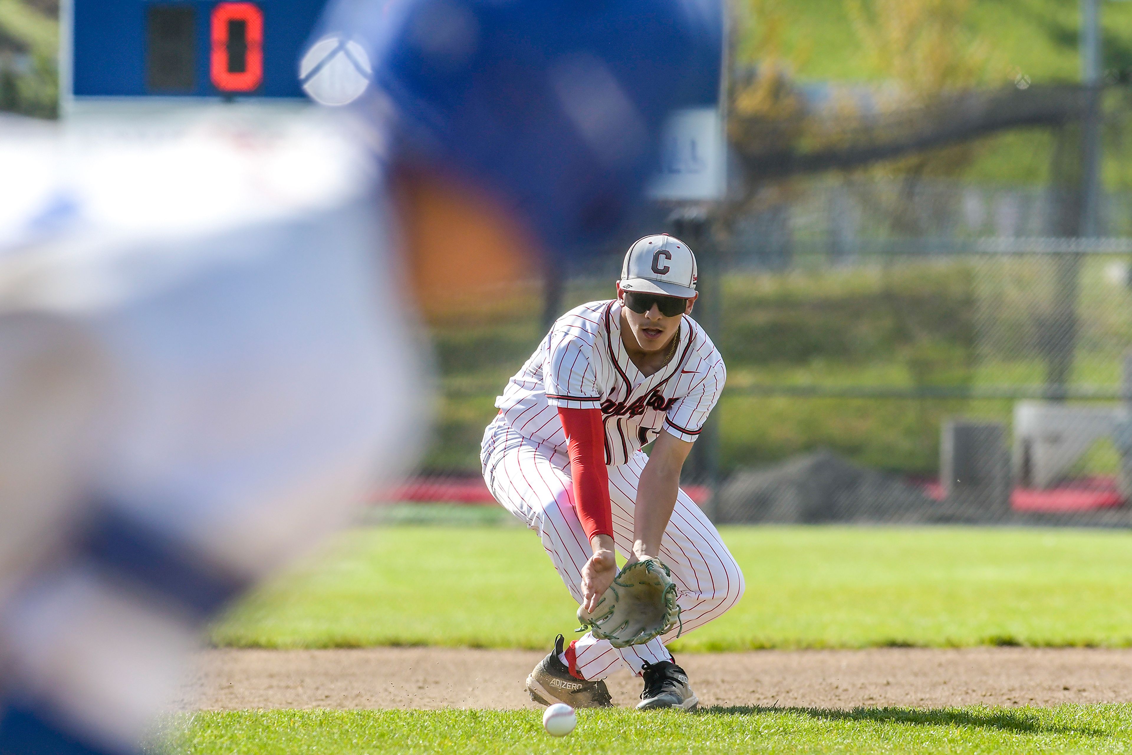 Clarkston third baseman Otis Phillips catches a ground ball before throwing to first to get the out against Pullman during a semifinal game of the district tournament Thursday in Pullman.