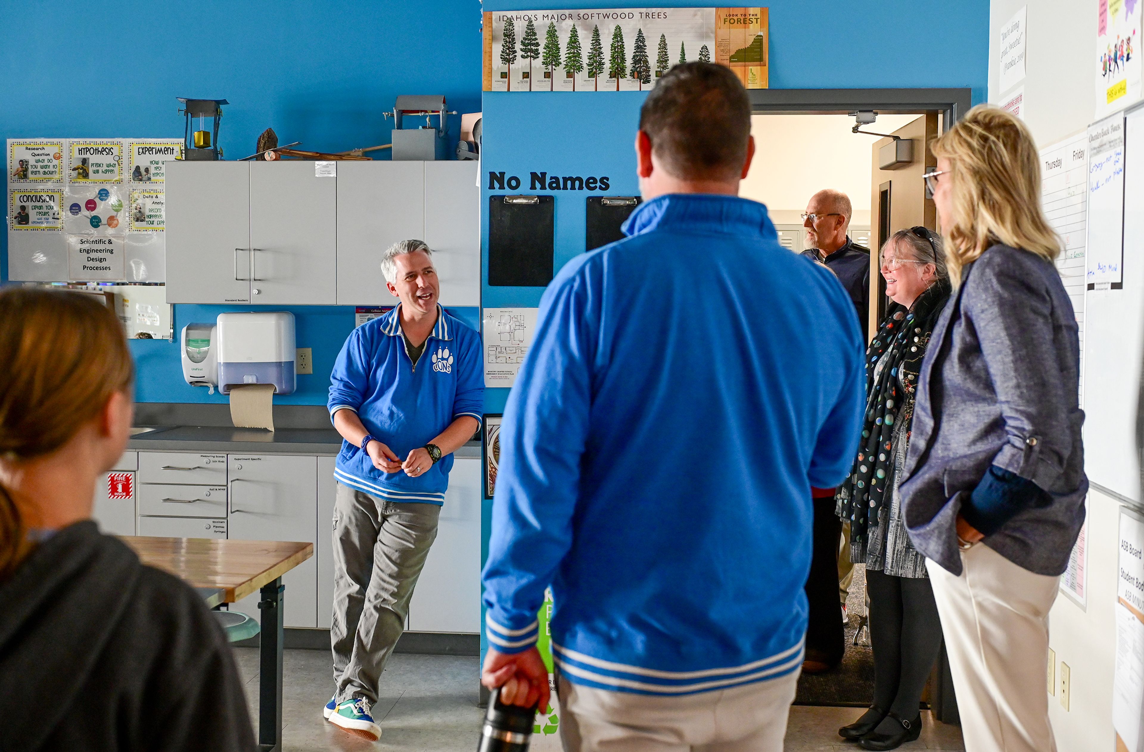 A tour of Moscow Charter School stops by the room of Paul Collins, left, the middle science and gifted and talented teacher, with Idaho Superintendent of Public Instruction Debbie Critchfield, right, Friday in Moscow.