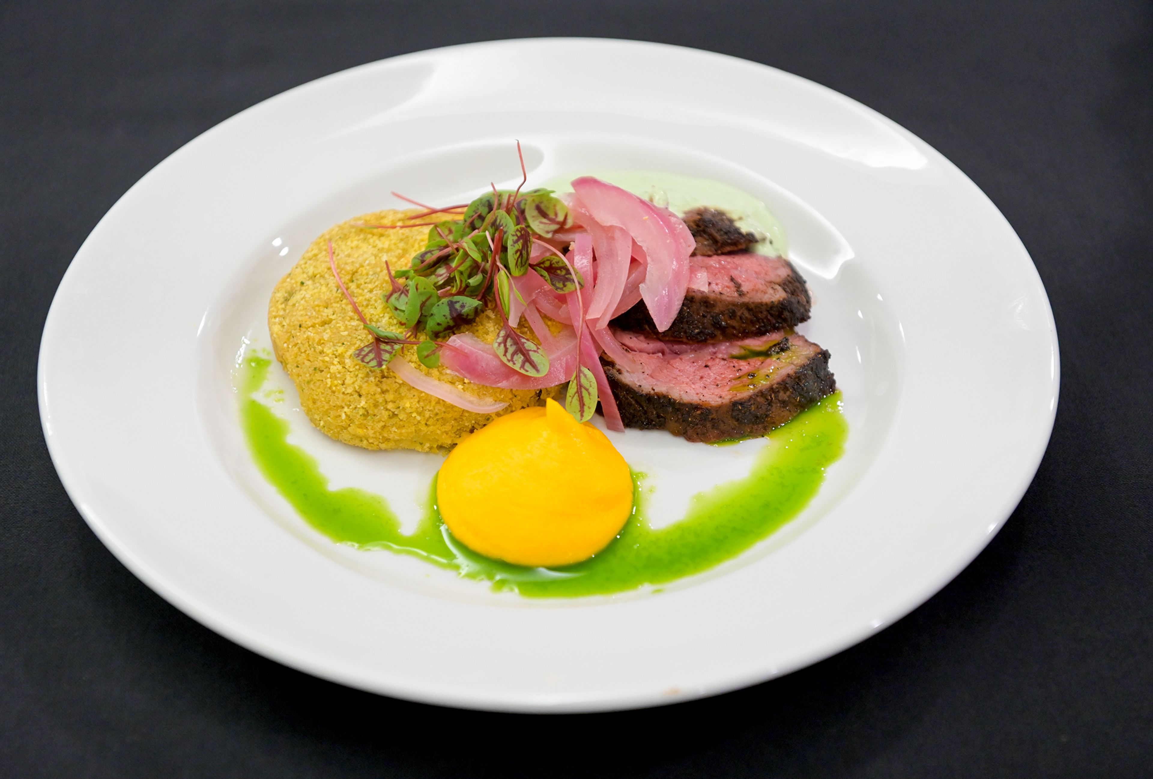 The winning Battle of the Chefs dish from Chef Michael Verk, an executive chef with the University of Idaho’s Idaho Eats, sits Wednesday at The Eatery on campus in Moscow. The dish consisted of pan seared coulotte steak with garbanzo bean pupusa, smoked carrot emulsion, pickled red onion and lime crema.