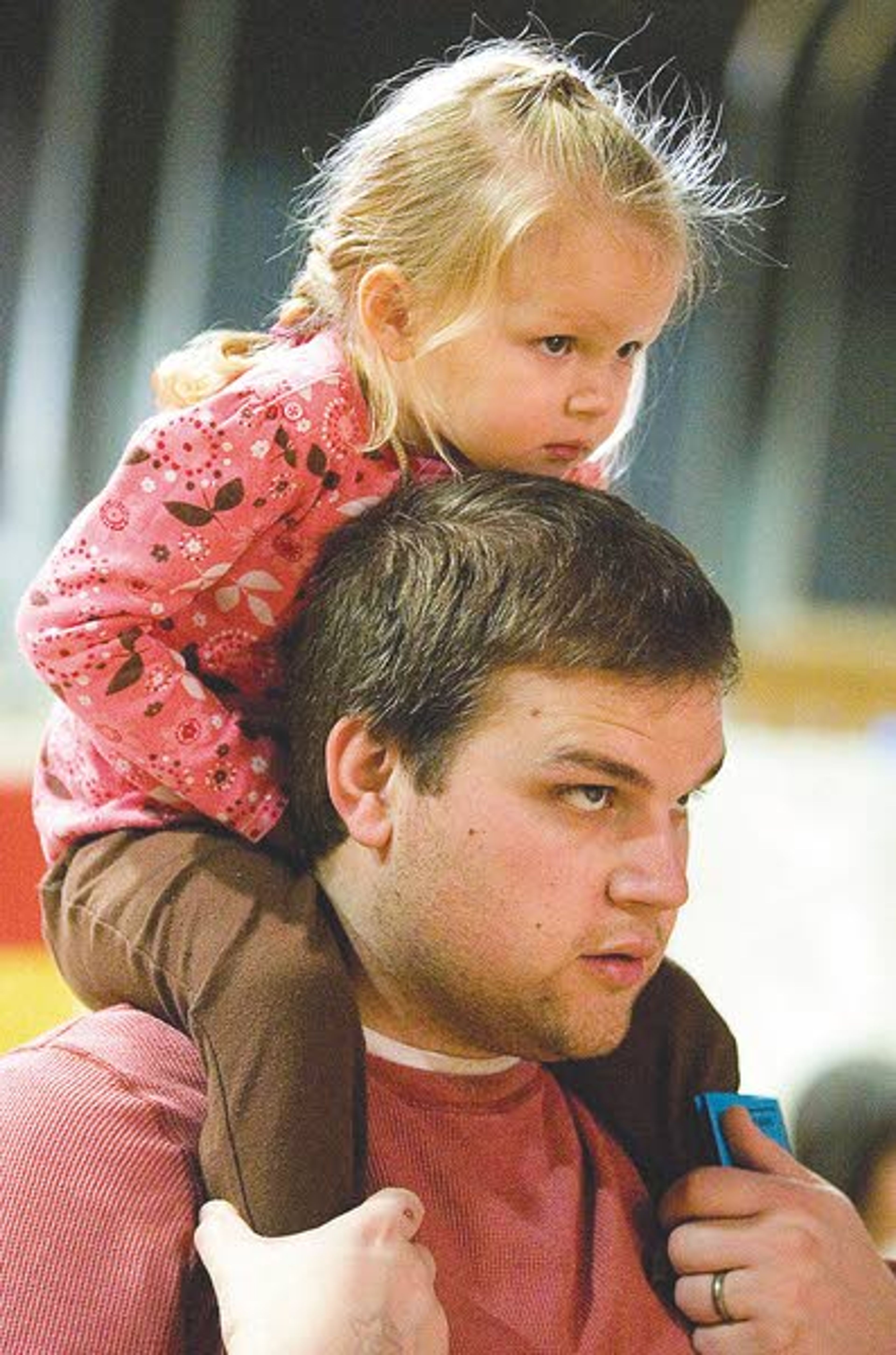 Abigail Nielsen, 2, of Pullman watches a Mexican dance while sitting on the shoulders of her father, Brian Nielsen, at Cruise The World in Moscow on Saturday.