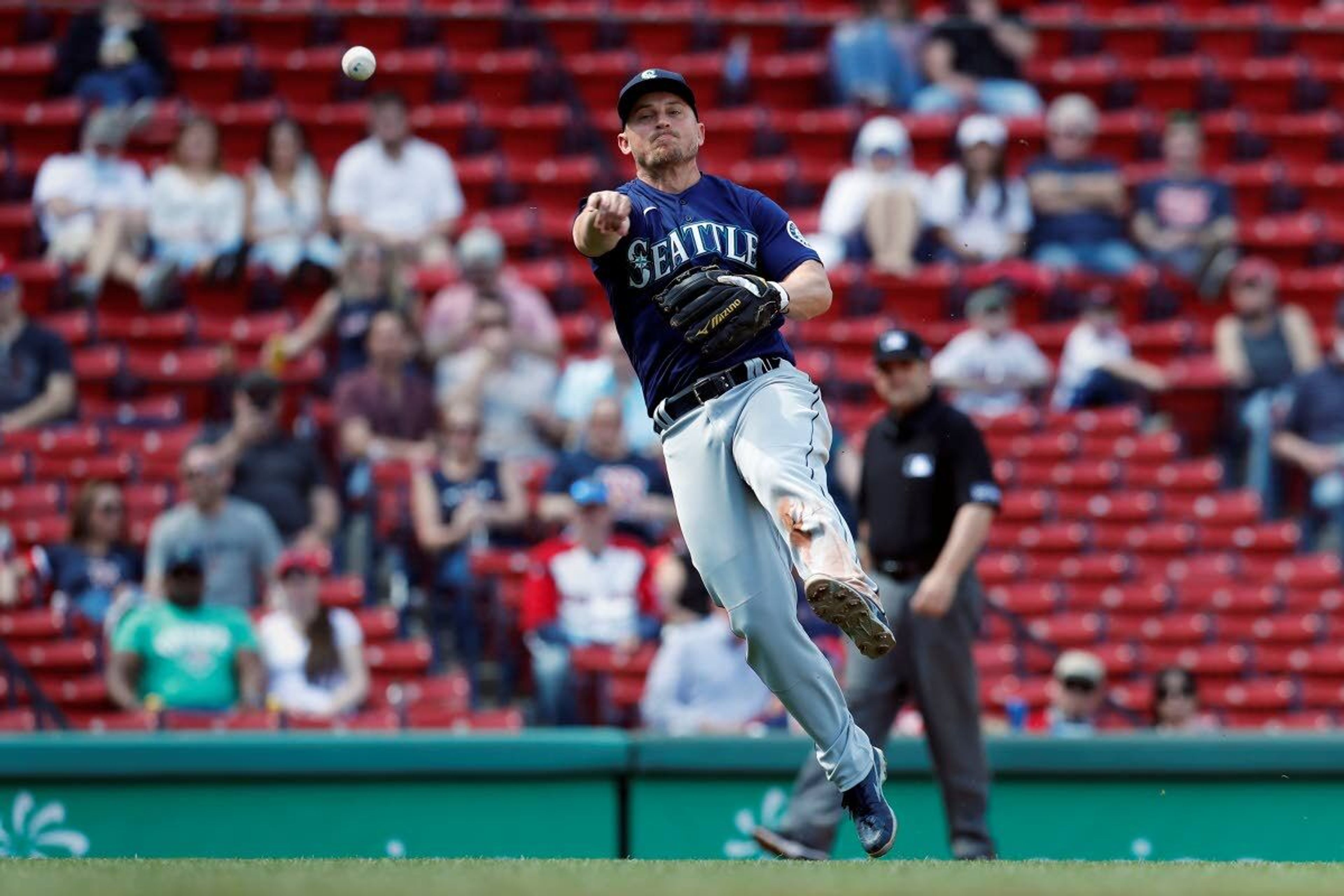 Seattle Mariners' Kyle Seager throws to first base on the ground out by Boston Red Sox's Christian Arroyo during the sixth inning of a baseball game, Saturday, April 24, 2021, in Boston. (AP Photo/Michael Dwyer)