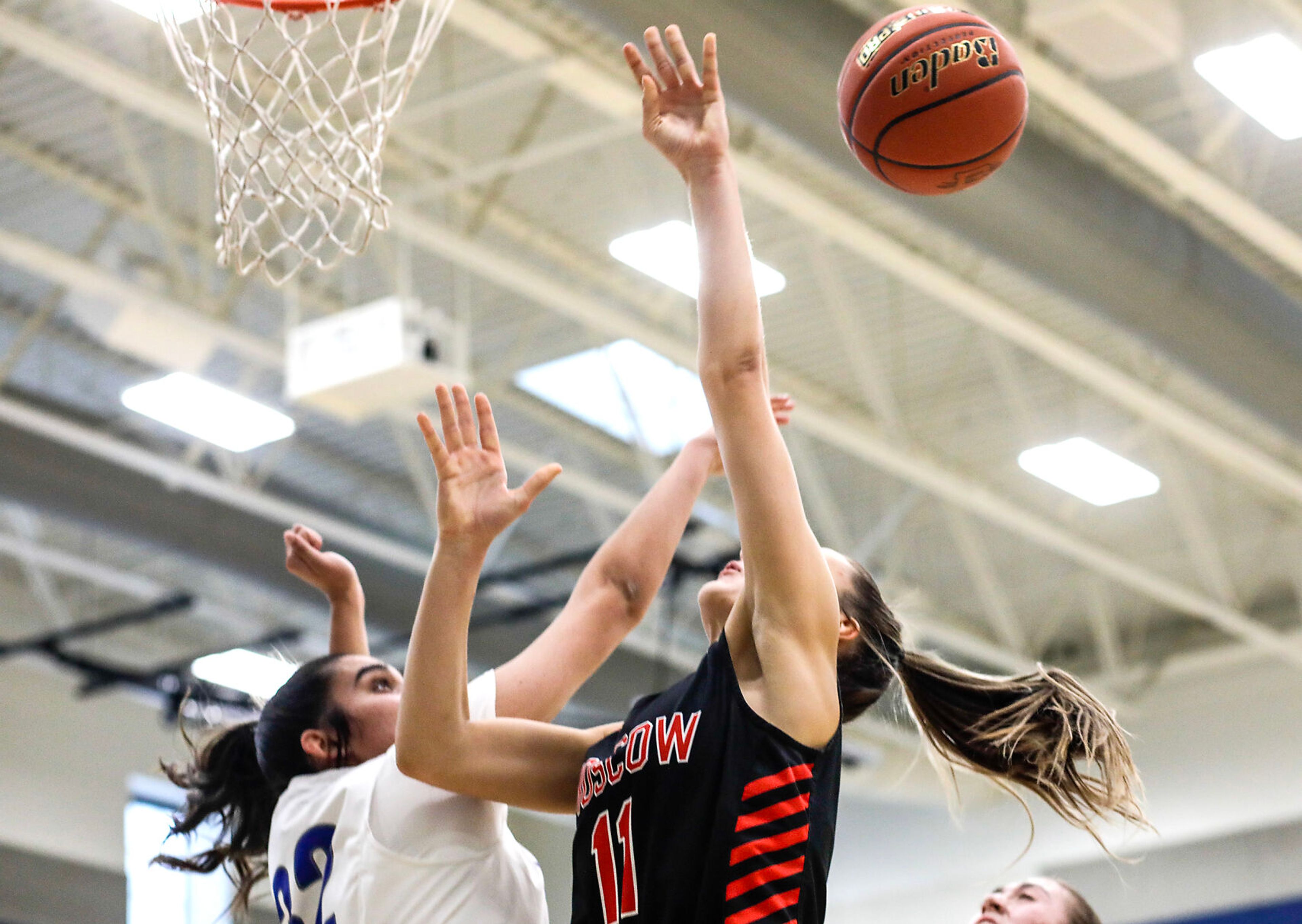 Pullman post Marissa Carper, left, blocks the shot of Moscow guard/forward Maya Anderson during Saturday's nonleague girls basketball game.