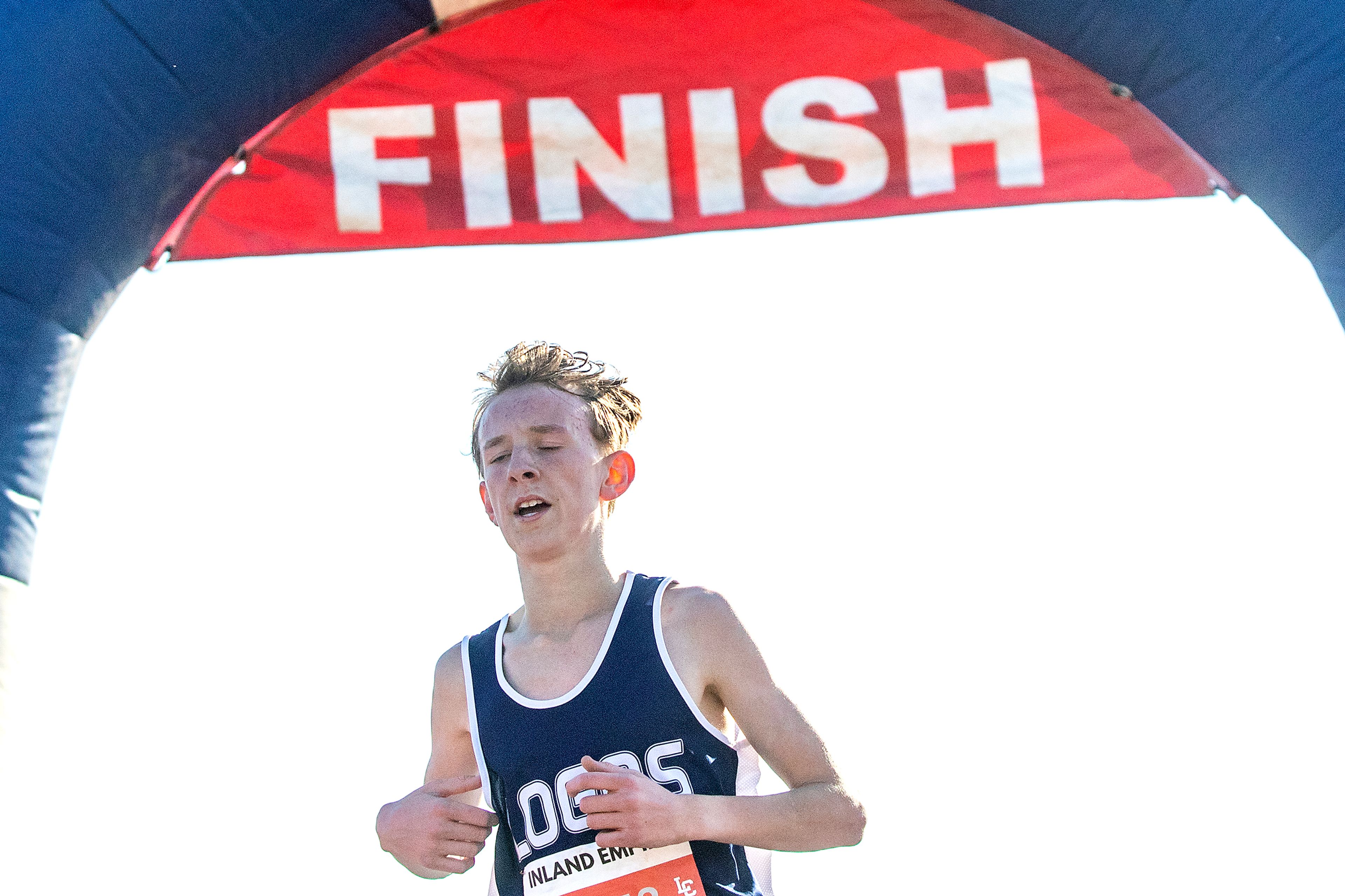 Logos’ Simeon Rauch comes through the finish line at the Class 1A district cross country meet in Lewiston on Wednesday.