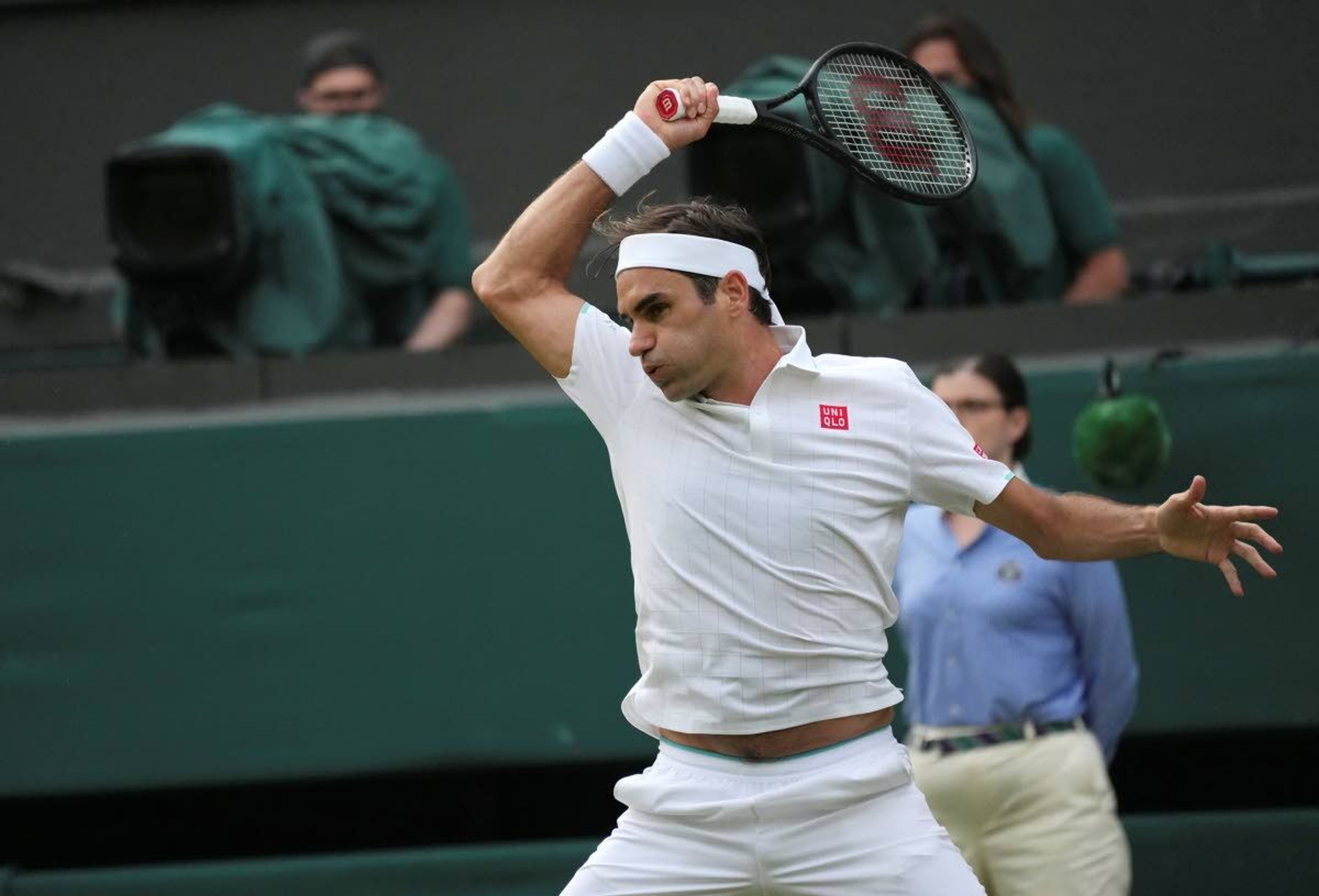 Switzerland's Roger Federer plays a return to Richard Gasquet of France during the men's singles second round match on day four of the Wimbledon Tennis Championships in London, Thursday July 1, 2021. (AP Photo/Alberto Pezzali)