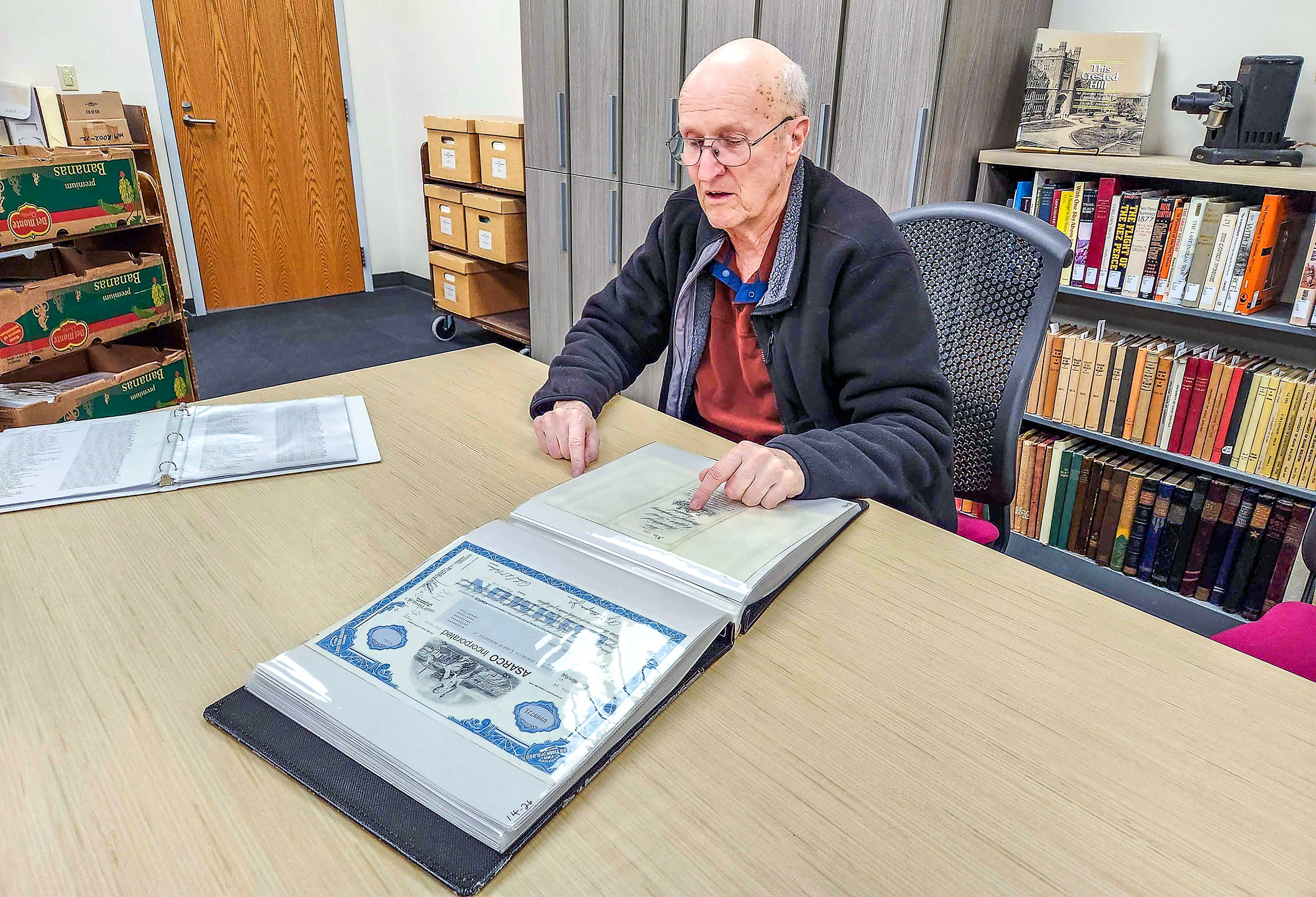 Earl Bennett displays some of the stock certificates he's bestowing to UI.