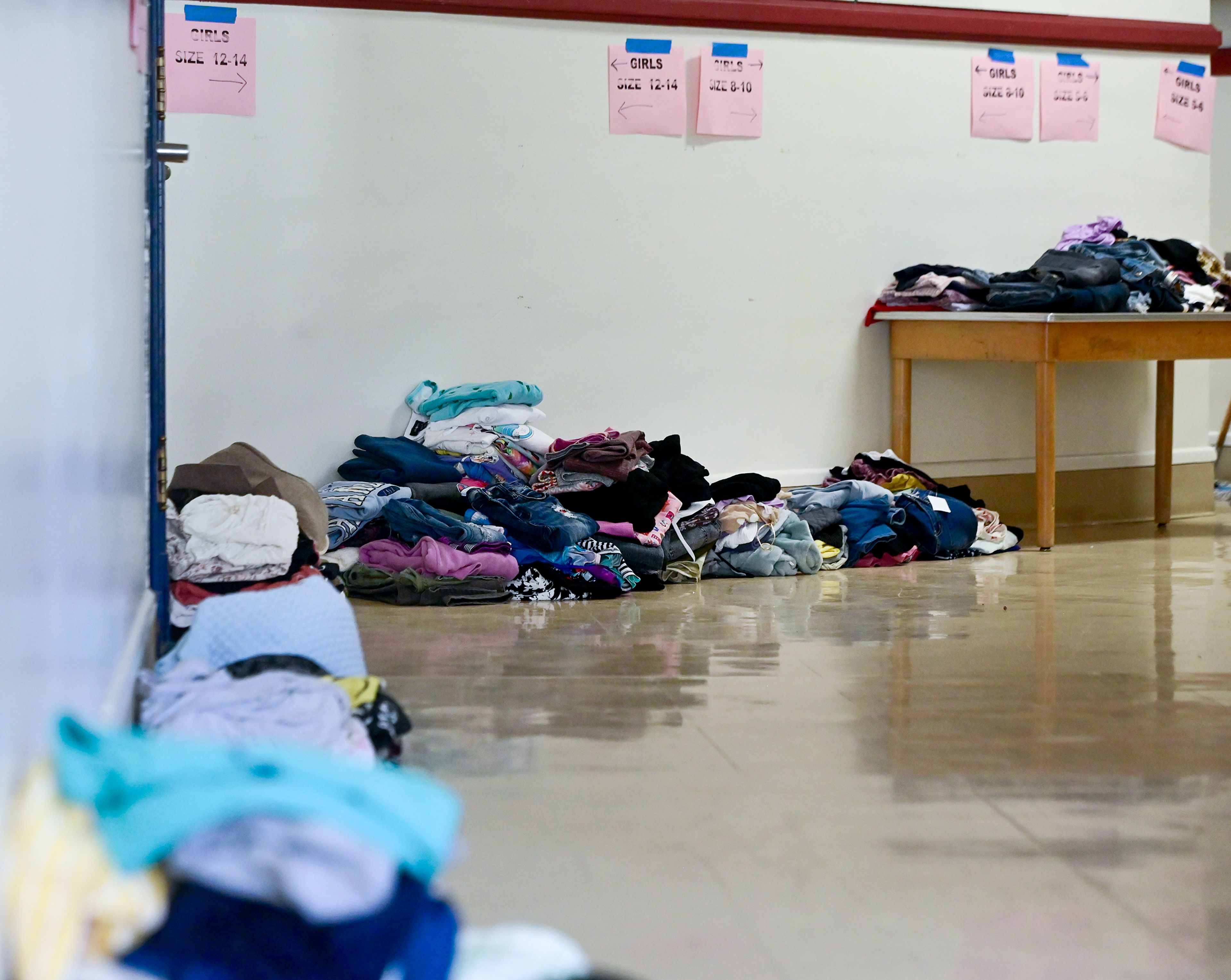 Piles of clothes organized by size line the hallways of Russell Elementary building Thursday before being stored in boxes or placed in the Moscow School District Family Resource Hub in Moscow.