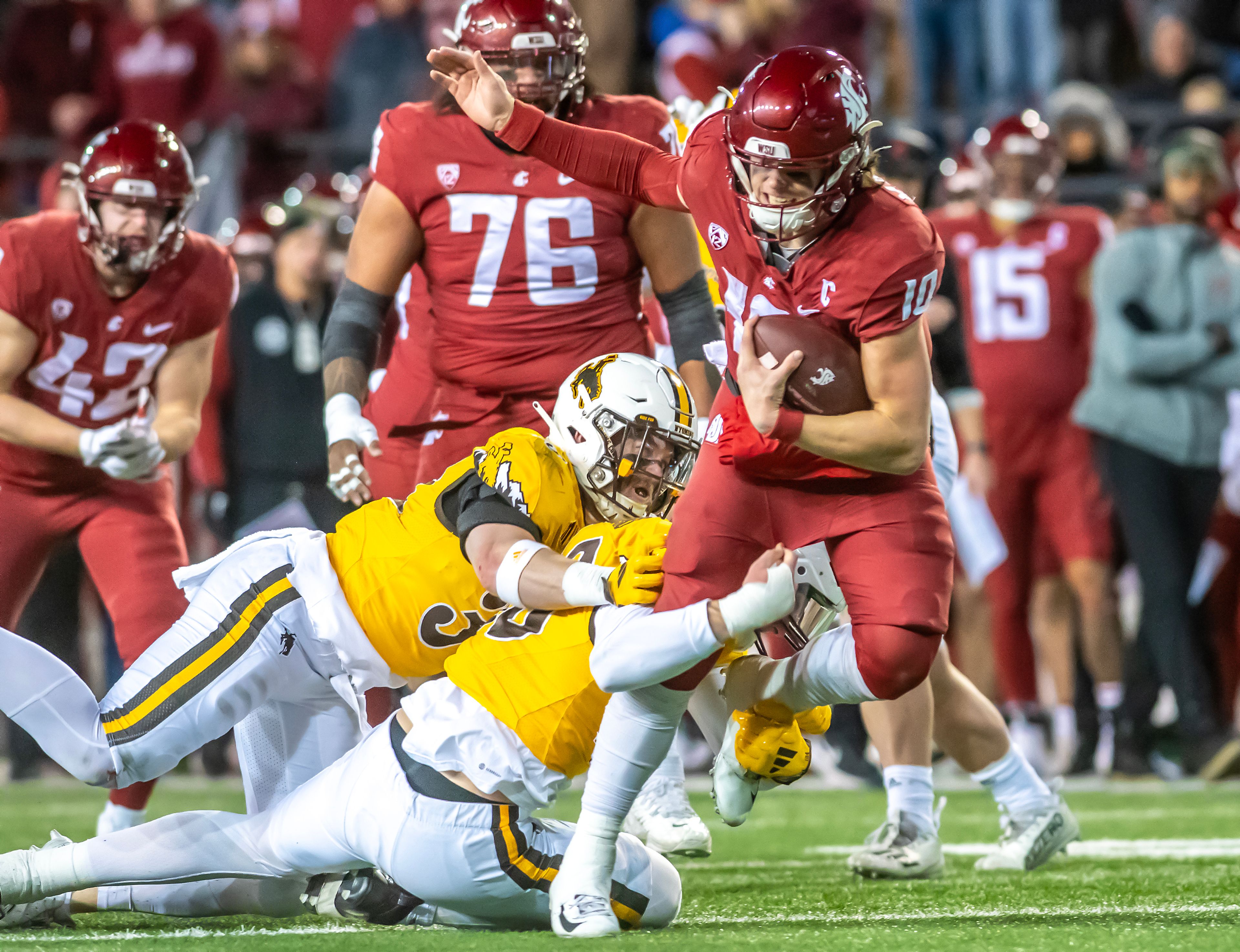 Washington State quarterback John Mateer runs the ball as Wyoming defensive end Tyce Westland tackles him during a quarter of a college football game on Saturday, at Gesa Field in Pullman.