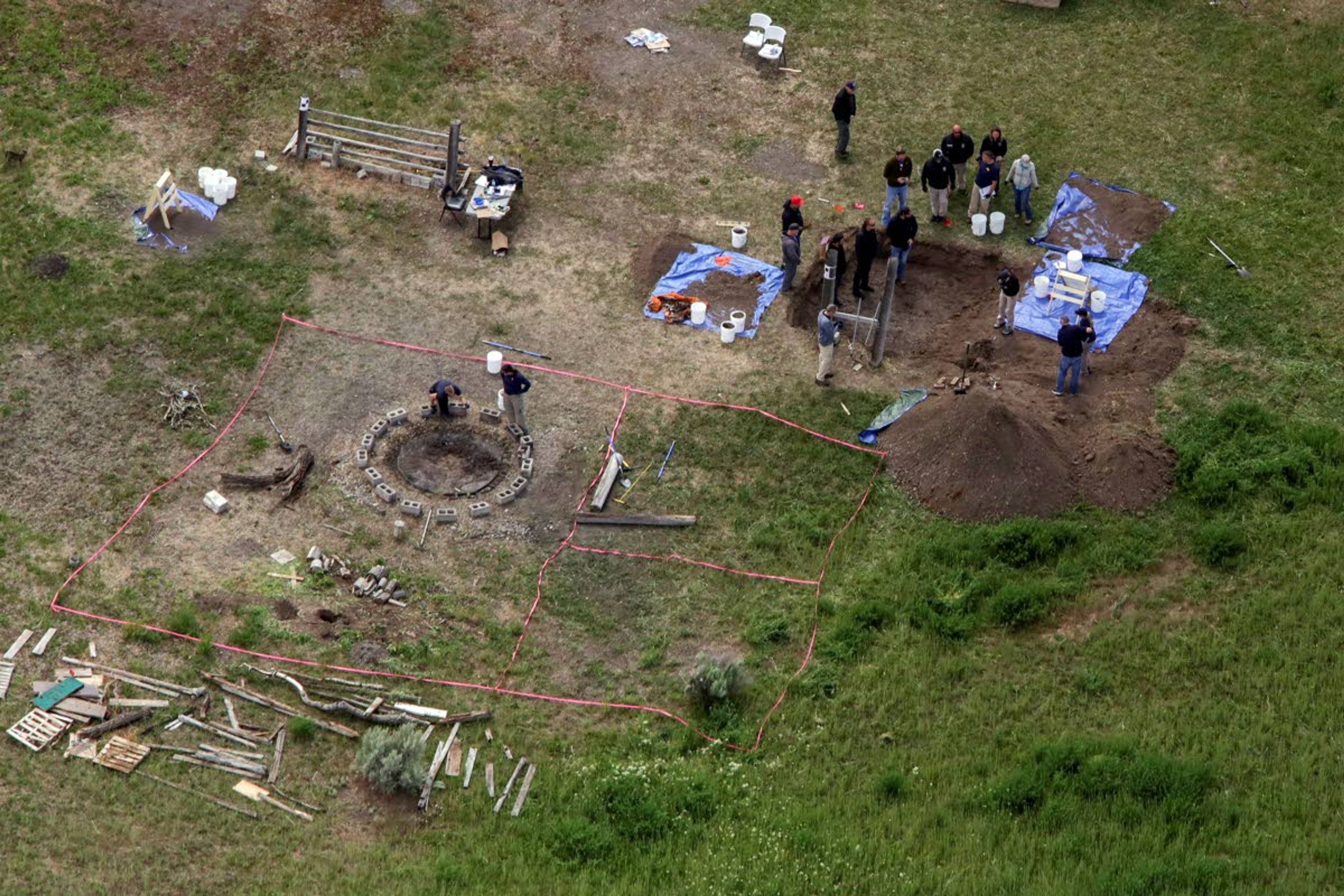 FILE - In this Tuesday, June 9, 2020, file aerial photo, investigators search for human remains at Chad Daybell's residence in the 200 block of 1900 east, in Salem, Idaho. Court documents say authorities used cellphone information from the now-deceased uncle of two missing Idaho children to find the youths' bodies on Daybell's rural property. Daybell and the children's mother, Lori Vallow Daybell, are in custody. (John Roark/The Idaho Post-Register via AP, File)