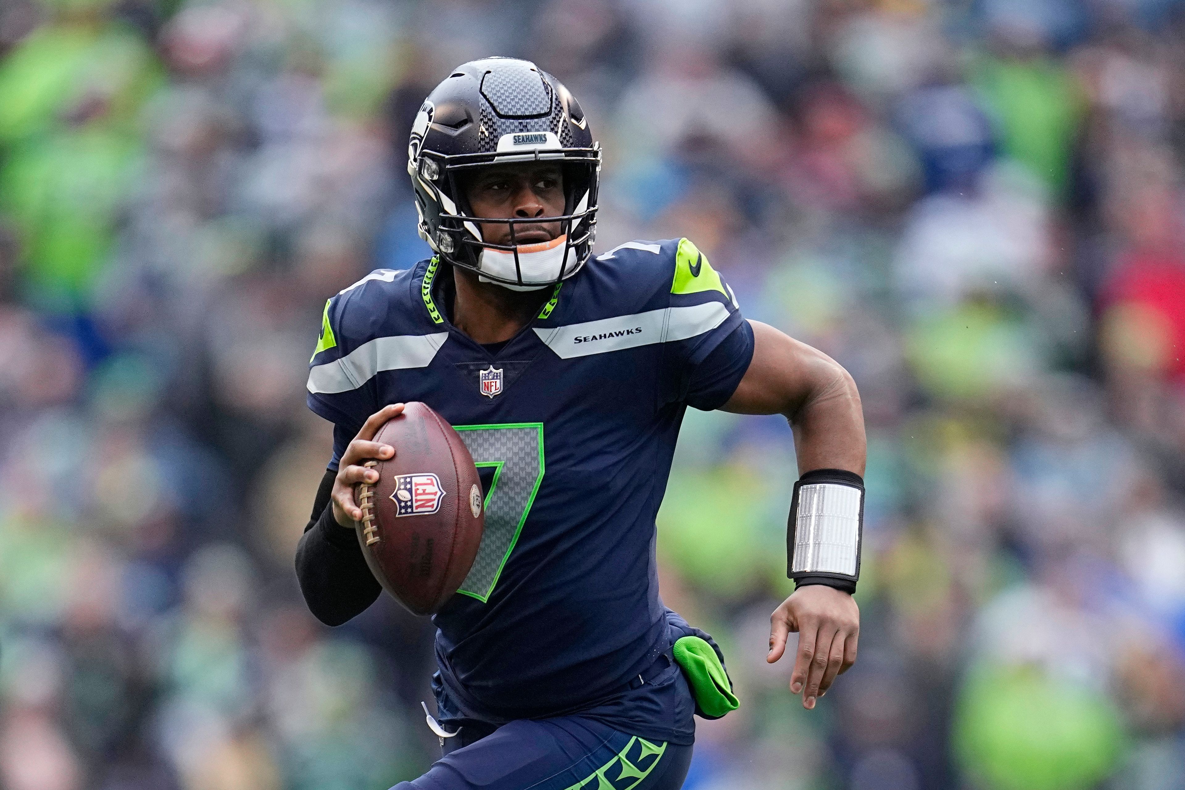 FILE - Seattle Seahawks quarterback Geno Smith (7) runs with the ball during the first half of the team's NFL football game against the Los Angeles Rams, Jan. 8, 2023, in Seattle. Geno Smith finally got to enjoy a day of being in the spotlight after signing the big contract that had eluded most of his career. Smith's three-year contract with the Seahawks will keep him as the presumptive starting quarterback in Seattle following a breakout season. (AP Photo/Abbie Parr, File)