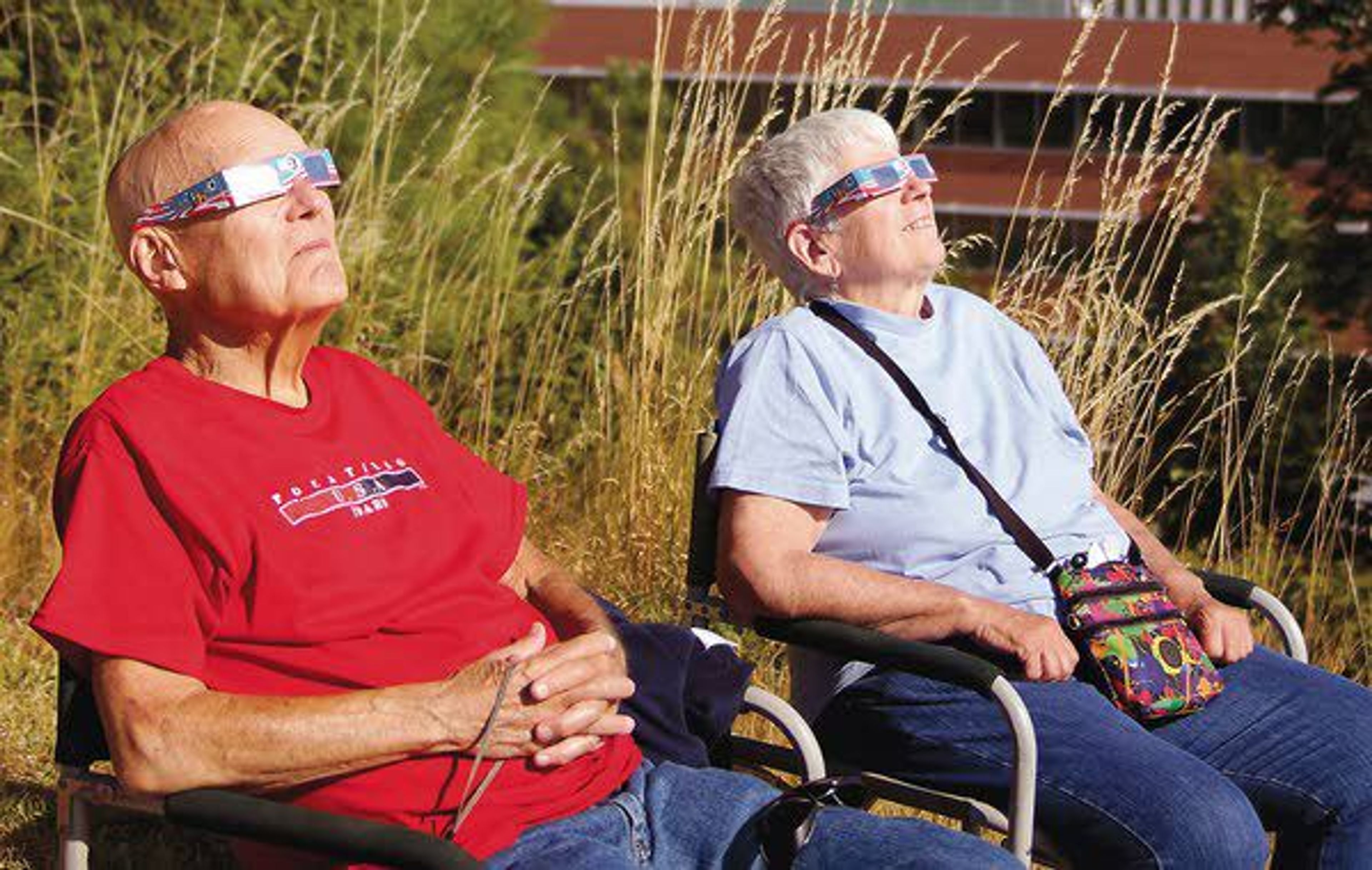 Jack Beebe and Jane Seymour, of Massapequa, N.Y., watch the solar eclipse Monday near the Jewett Observatory on the WSU campus in Pullman.