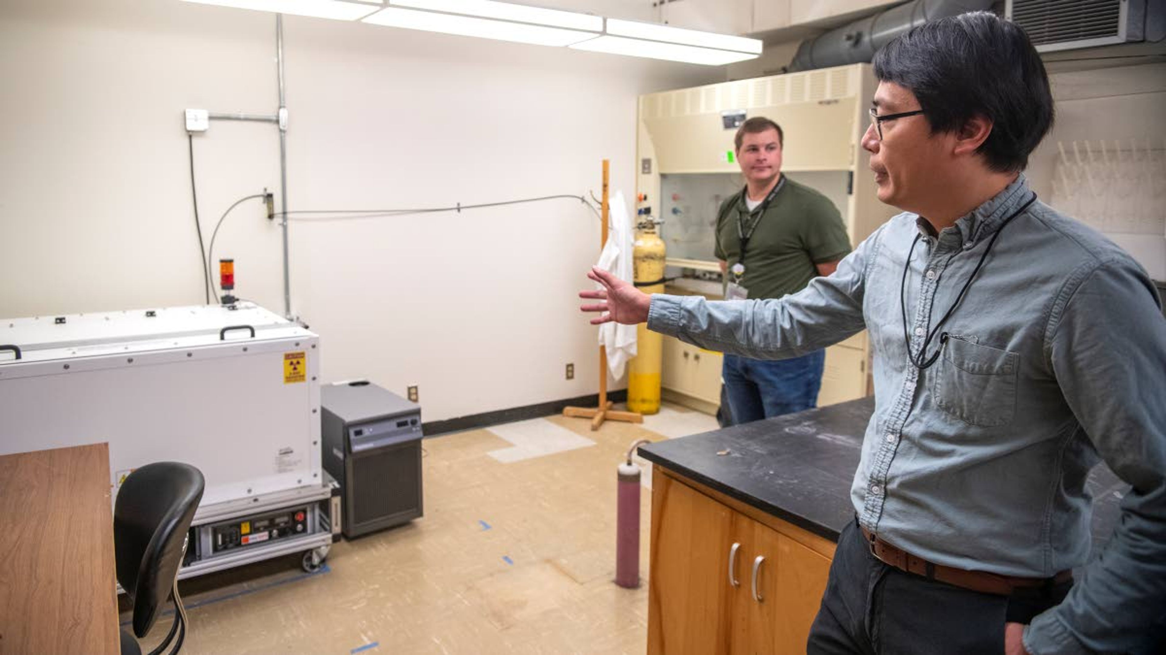 Research scientist and assistant professor Xiaofeng Guo explains the functionality of an easyXFS300+, which is used to collect data for rapid measurements and x-ray emissions of radiation.