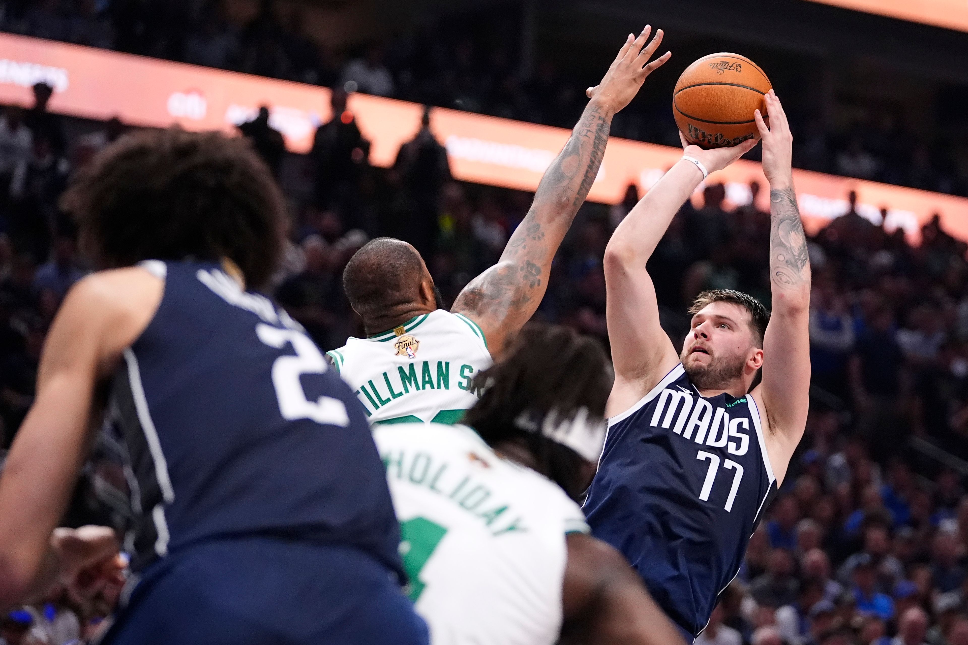 Mavericks guard Luka Doncic (77) shoots over Celtics forward Xavier Tillman, center, Friday during the first half of Game 4 of the NBA Finals at Dallas.