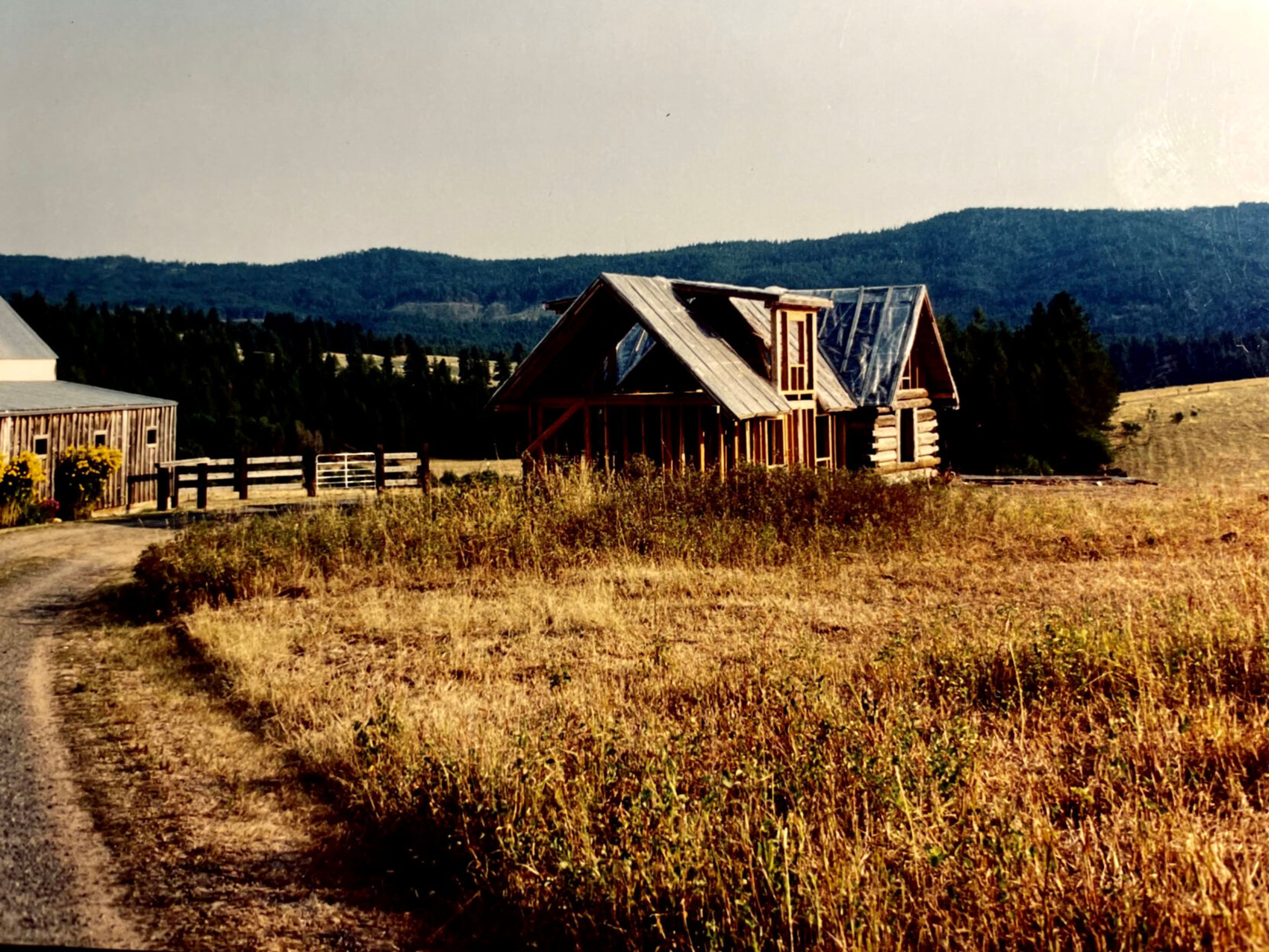 The Hatter Creek cabin and addition are shown in 2003 with Moscow Mountain in the background.