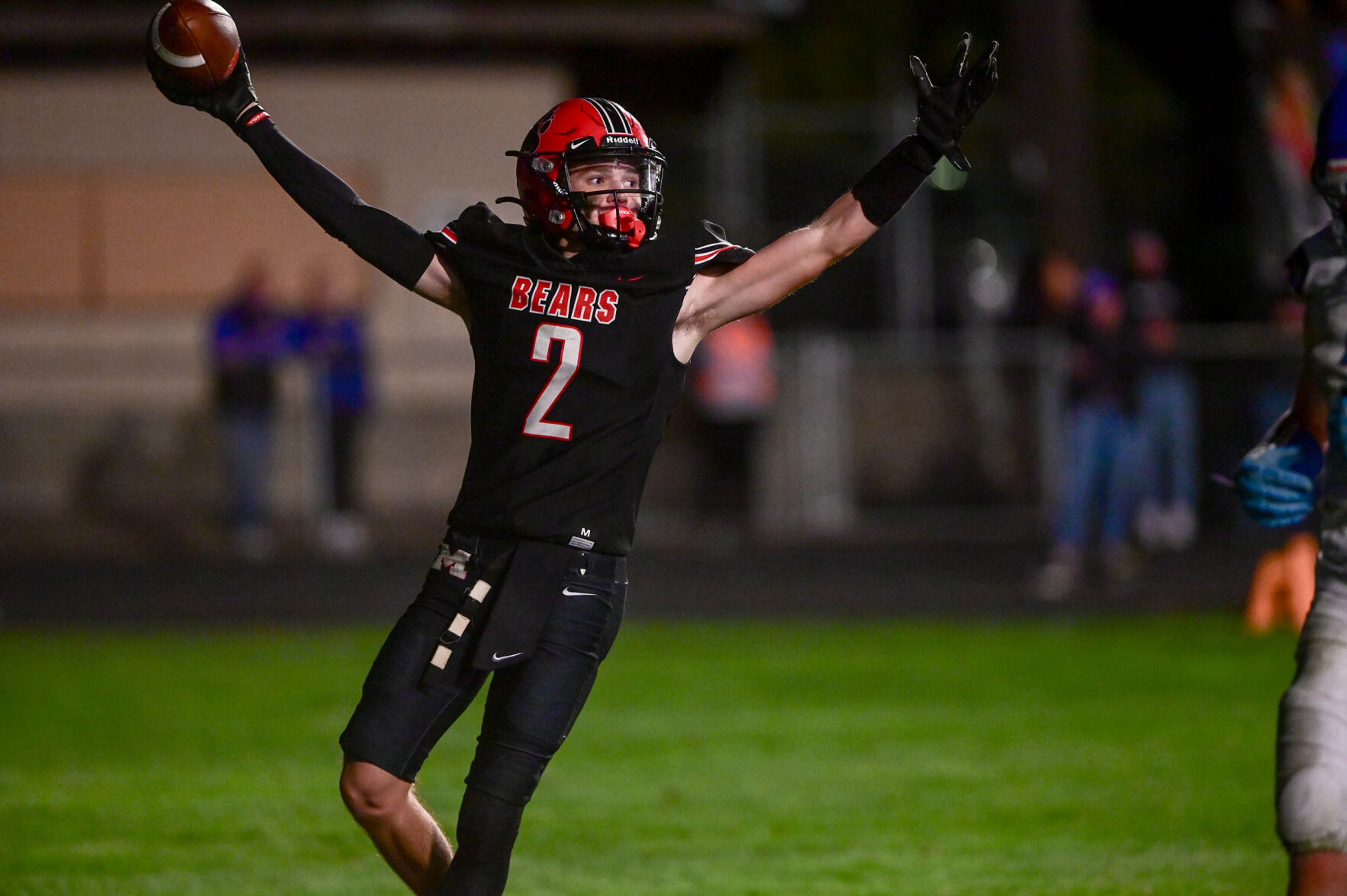 Moscow wide receiver Butch Kiblen raises his arms after running into the end zone in overtime play against Pullman Friday in Moscow.