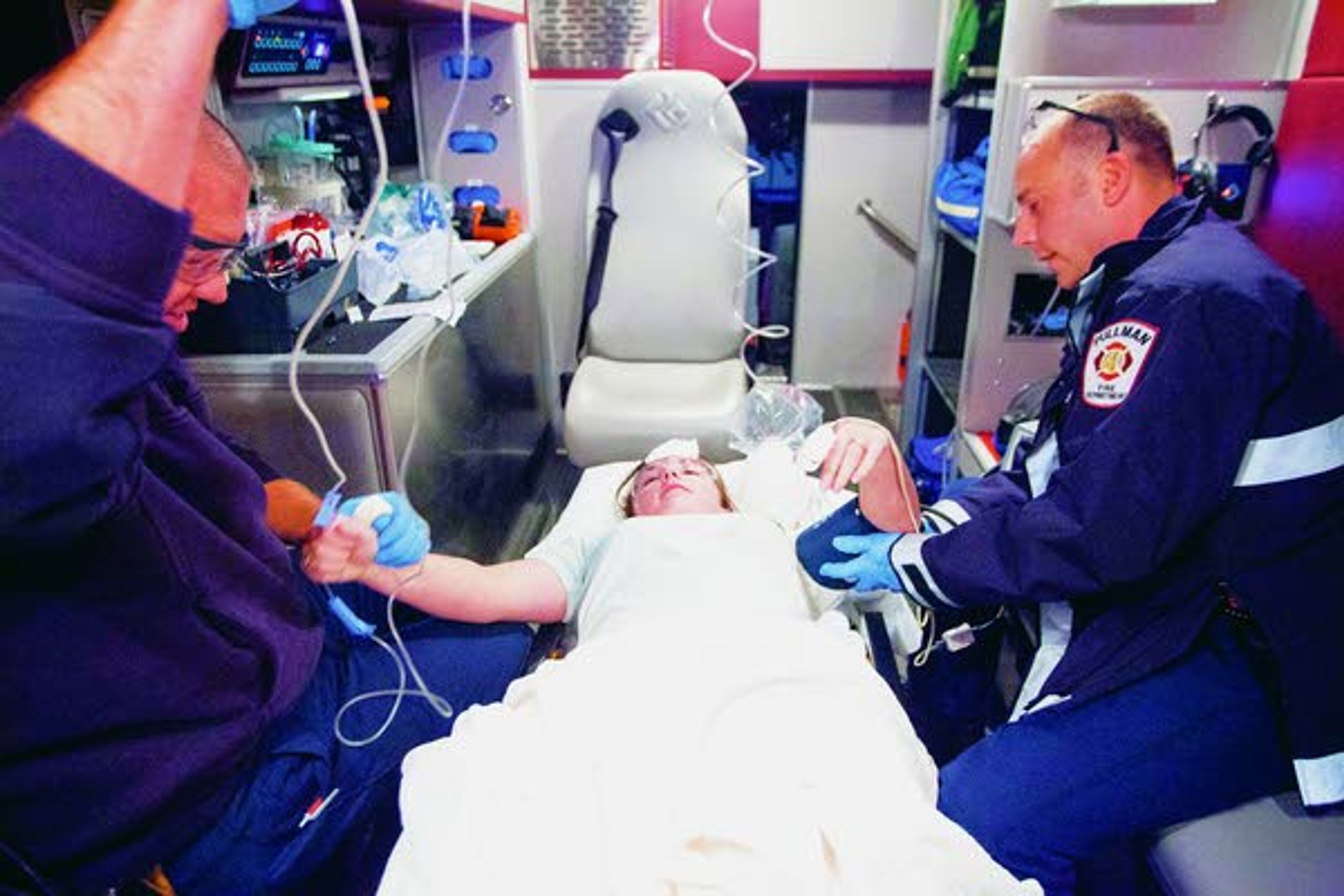 Pullman Fire Department paramedic Tony Nuttman, left, and firefighter Chris Koeppel treat simulated gunshot wound victim Caitlin Carl in an ambulance during an active shooter response drill run by the Pullman Police Department on Sunday at Summit Therapy in Pullman.