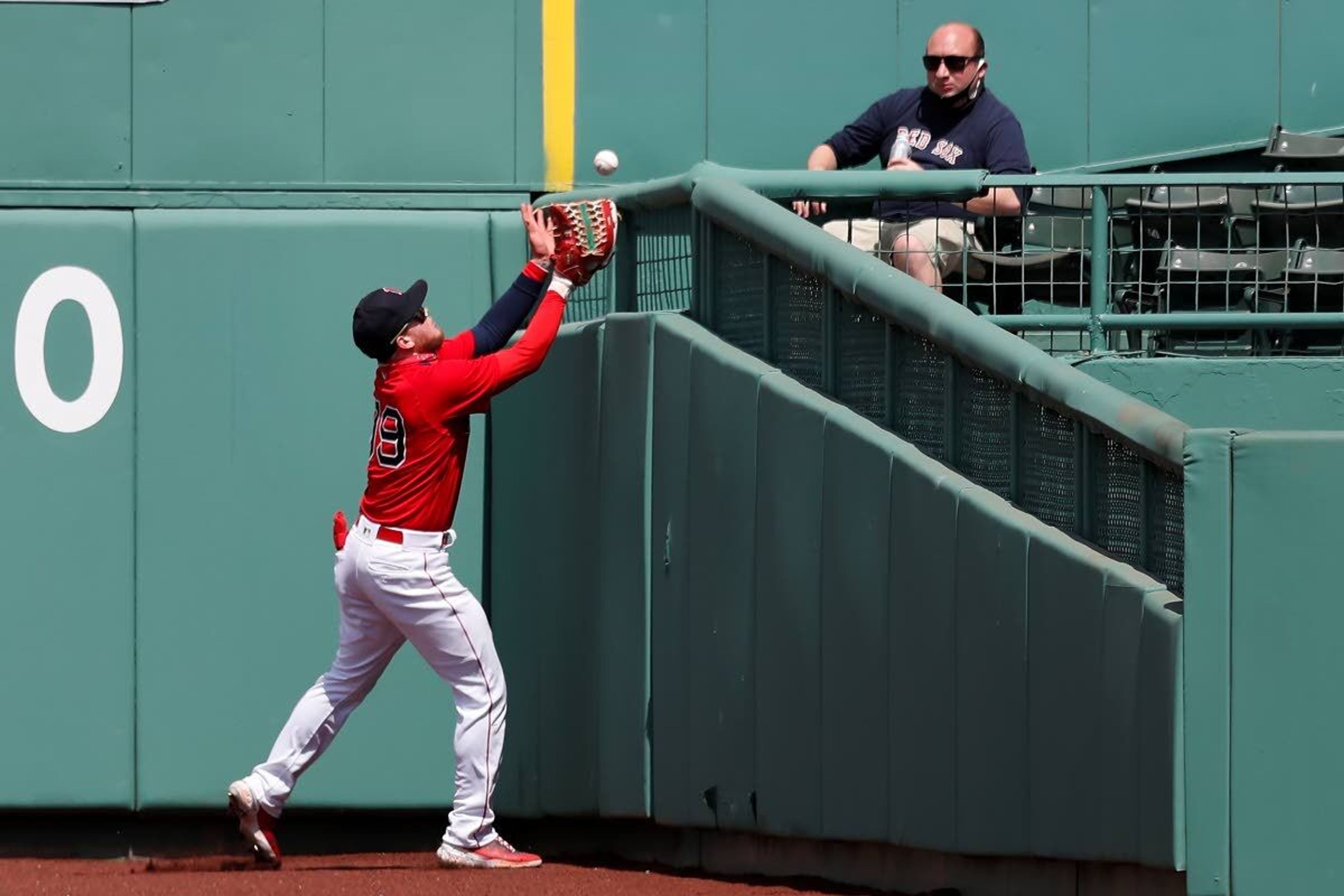 Boston Red Sox's Alex Verdugo fields a two-run triple by Seattle Mariners' Kyle Seager during the second inning of a baseball game Saturday, April 24, 2021, in Boston. (AP Photo/Michael Dwyer)