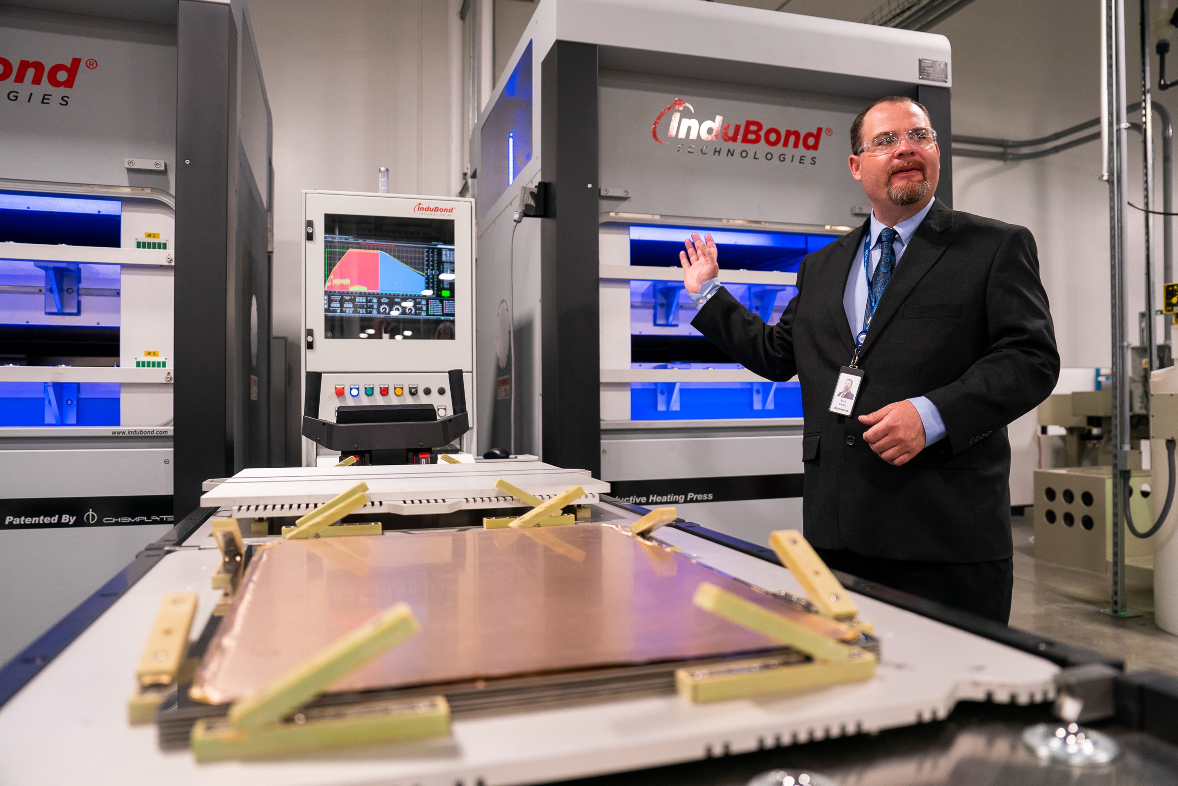 Schweitzer Engineering Laboratories employee Nick Swan talks about pressing machines during a tour of SEL’s new printed circuit board factory in Moscow on Wednesday.