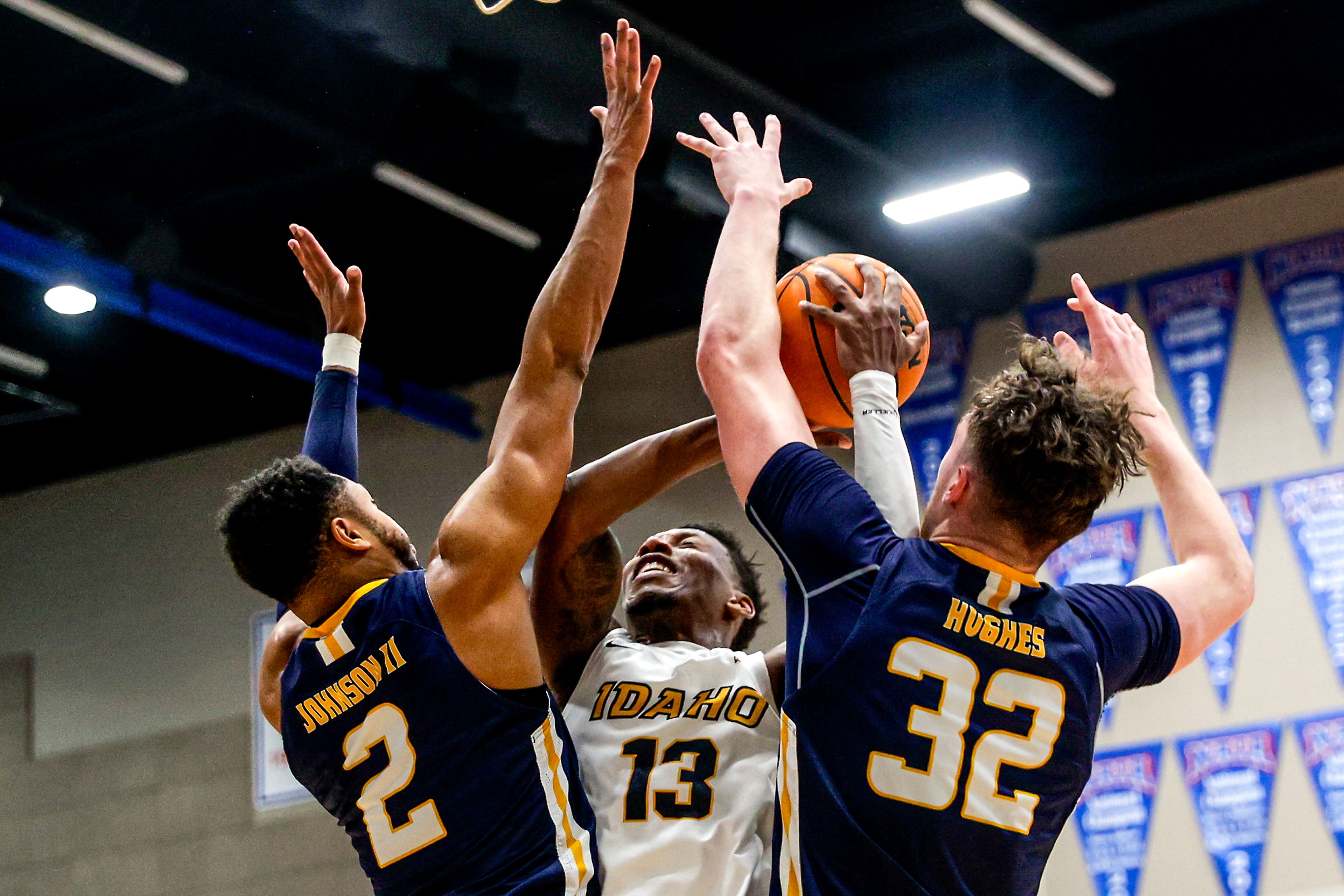 Idaho guard Divant'e Moffitt attempts a shot through Northern Colorado guard Matt Johnson II (2) and Northern Colorado center Theo Hughes in a Big Sky game at the P1FCU Activity Center on the Lewis-Clark State College campus Thursday in Lewiston.