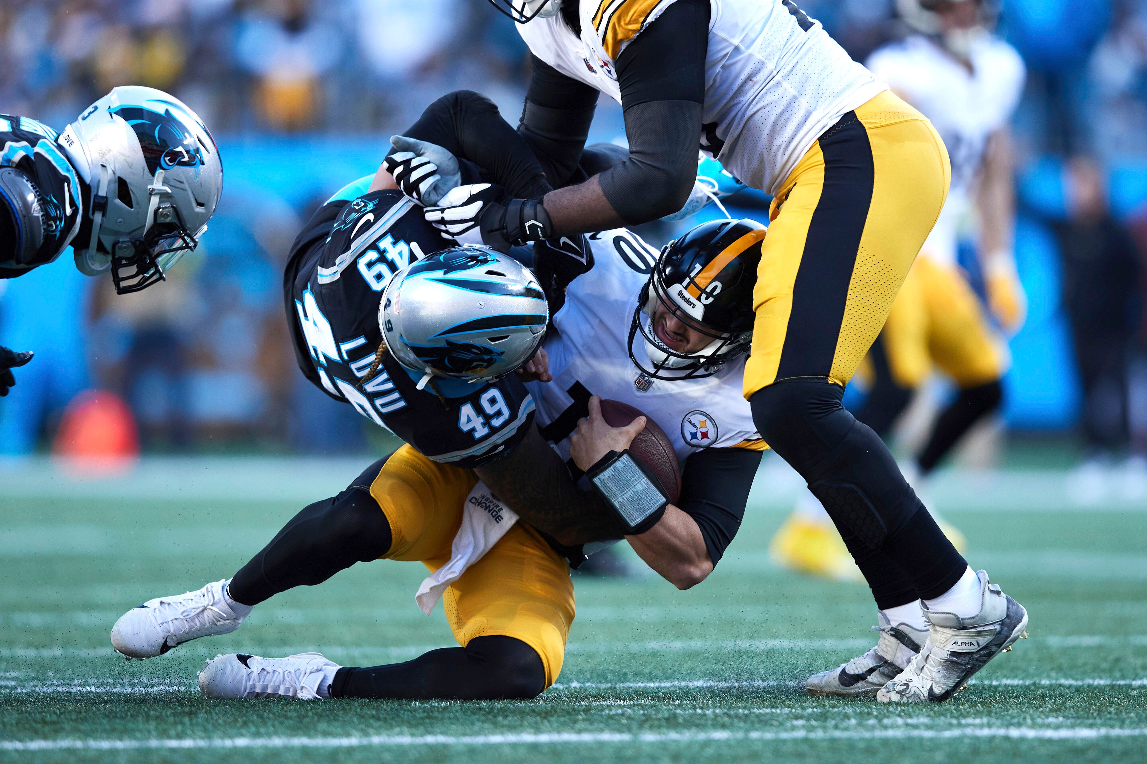 Pittsburgh Steelers quarterback Mitch Trubisky (10) is sacked by Carolina Panthers linebacker Frankie Luvu (49) during an NFL football game, Sunday, Dec. 18, 2022, in Charlotte, N.C. (AP Photo/Brian Westerholt)