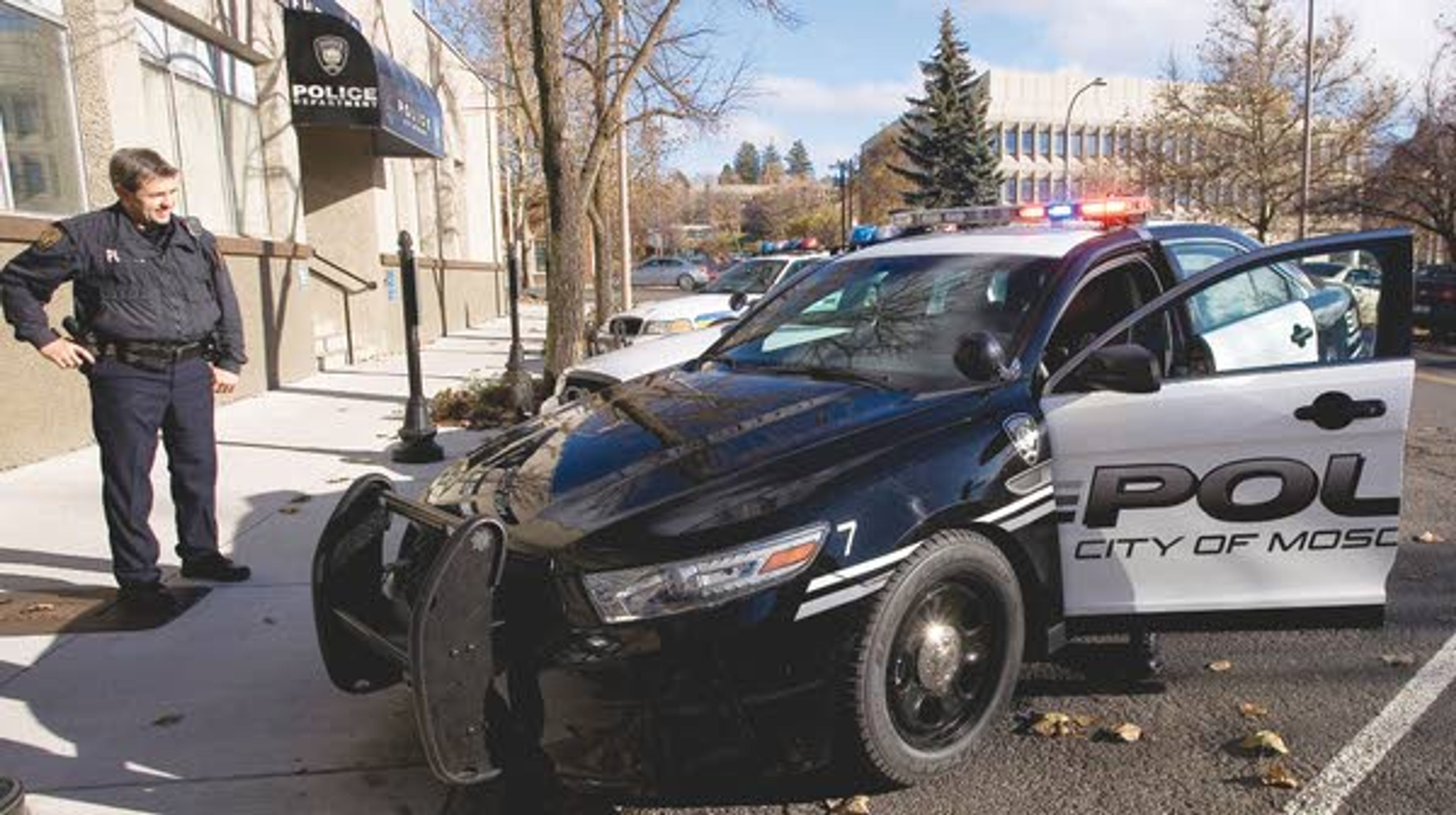 Lt. Paul Kwiatkowski, left, watches as patrol officer J.P. Knickerbocker turns on the lights and sirens on one of the new black-and-white painted Ford Taurus all-whel drive intercepters bought by the Moscow Police Department on Thursday.