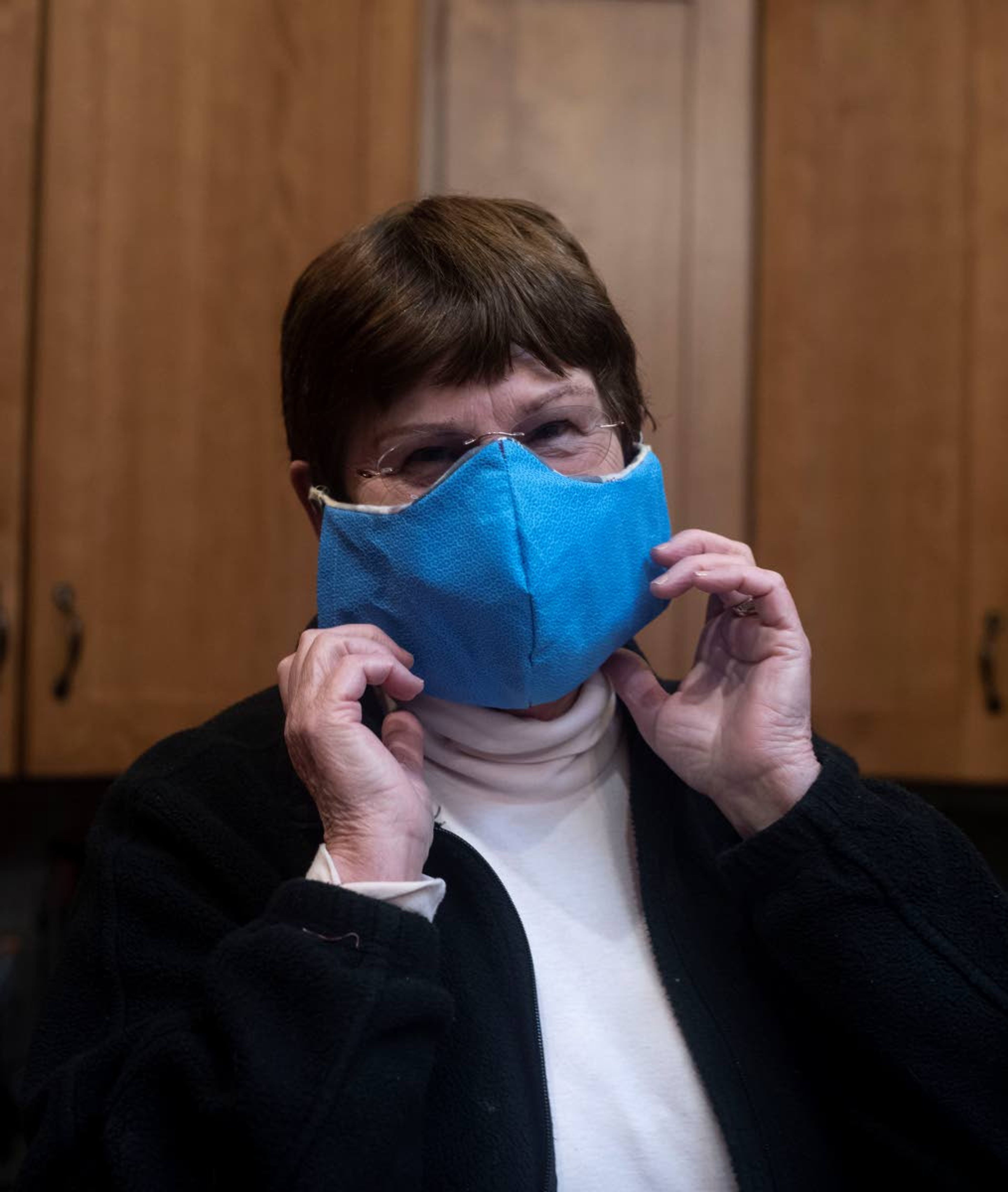 Sue Scott of Moscow holds up the newest version of her handmade masks. She said to create the structure for the nose of the mask she has used pipe cleaner, zip ties or even twist ties from bread bags.