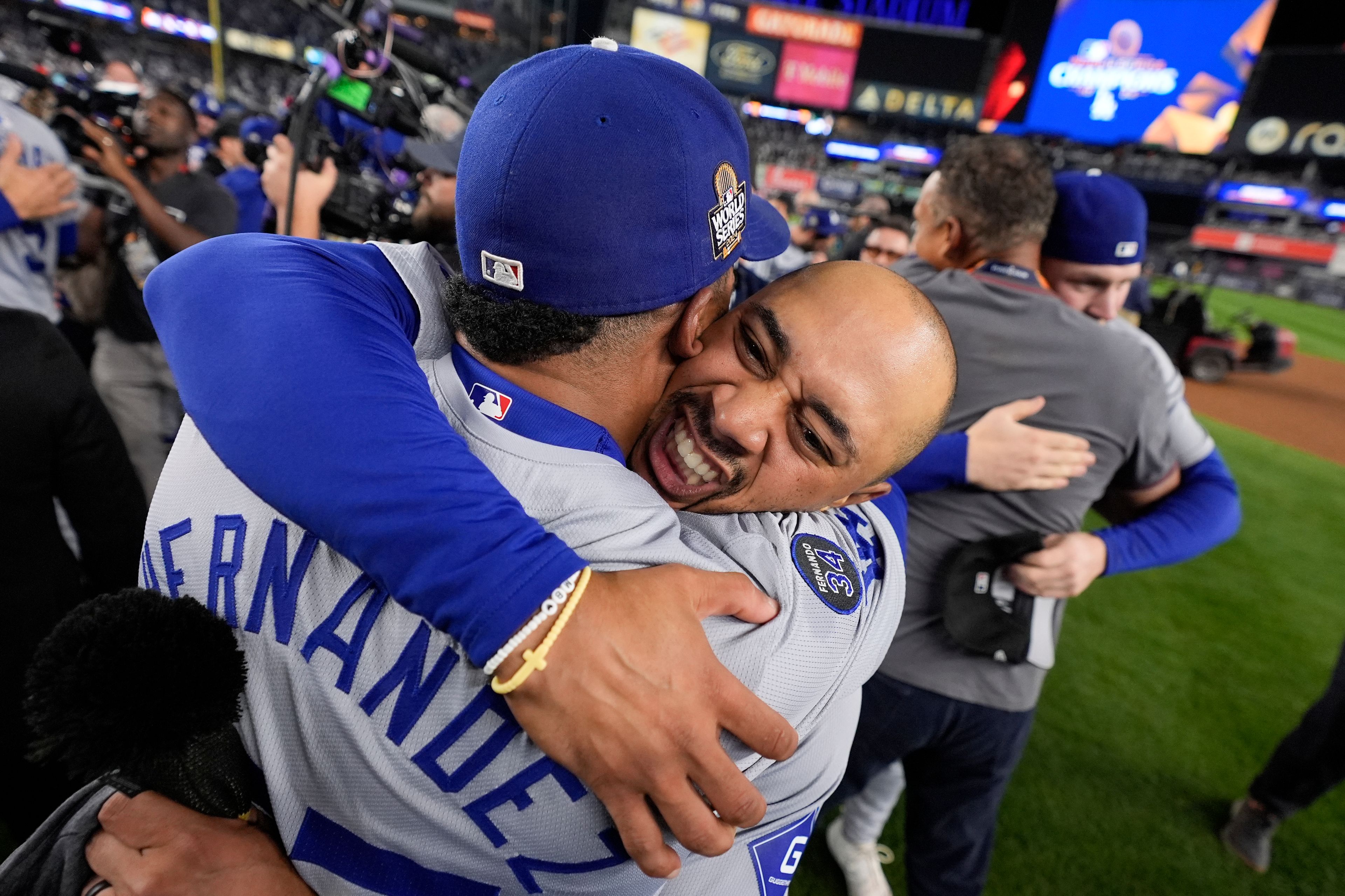 Los Angeles Dodgers' Freddie Freeman and Teoscar HernÃ¡ndez celebrate their win against the New York Yankees in Game 5 to win the baseball World Series, Wednesday, Oct. 30, 2024, in New York. (AP Photo/Ashley Landis)