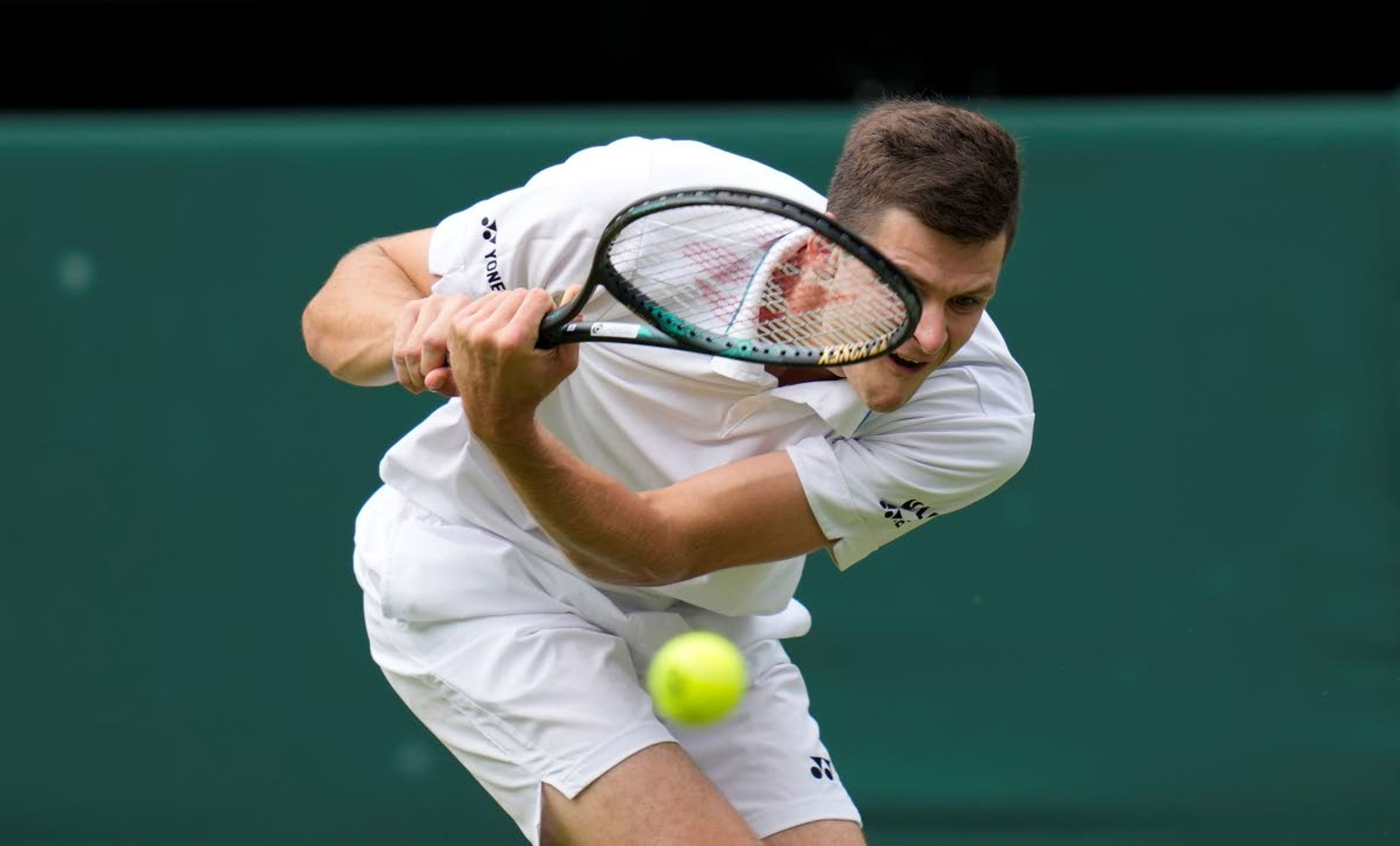 Poland's Hubert Hurkacz plays a return to Italy's Matteo Berrettini during the men's singles semifinals match on day eleven of the Wimbledon Tennis Championships in London, Friday, July 9, 2021. (AP Photo/Kirsty Wigglesworth)