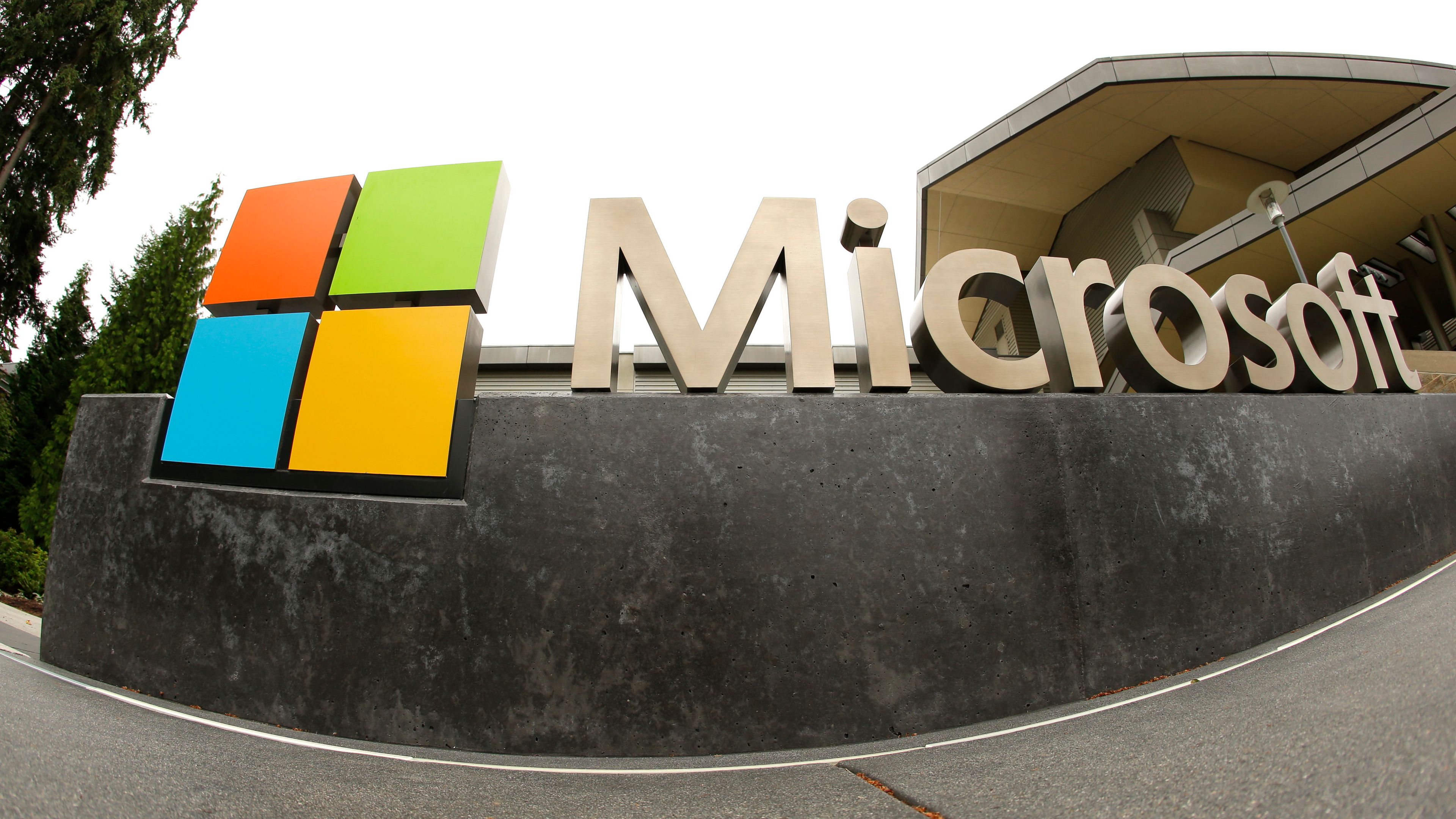 FILE - This July 3, 2014, file photo, shows the Microsoft Corp. logo outside the Microsoft Visitor Center in Redmond, Wash. Microsoft is cutting 10,000 workers, almost 5% of its workforce, in response to “macroeconomic conditions and changing customer priorities.”The company said in a regulatory filing Wednesday, Jan. 18, 2023 that had just notified employees of the layoffs, some of which begin immediately.The company said it will also be making changes to its hardware portfolio and consolidating its leased office locations -- all of which are designed to save about $1.2 billion. (AP Photo Ted S. Warren, File)