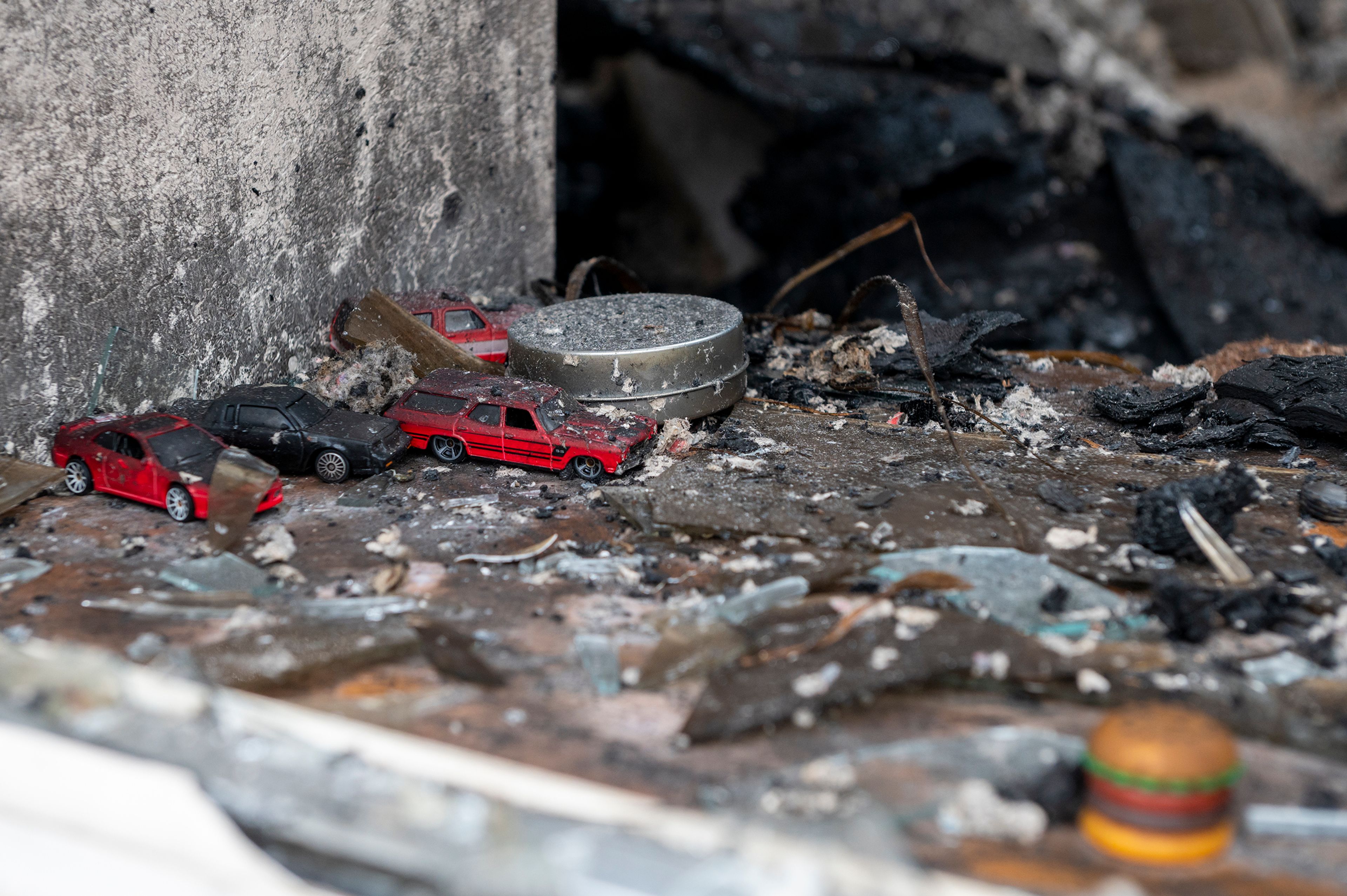 Items including toy cars are mixed in debris from the aftermath of a fire early Sunday morning at the Oxford House in Moscow.