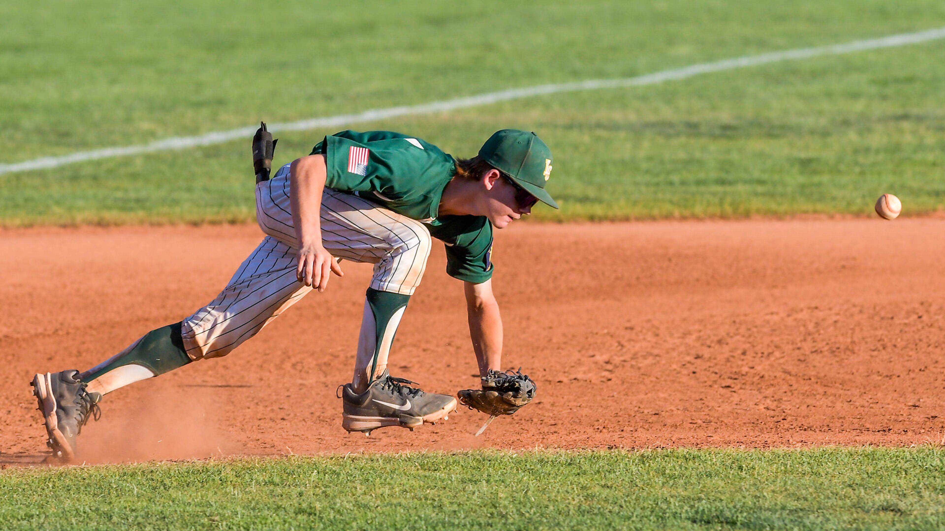 Lewis-Clark Cubs third baseman Cody Blackwell attempts to field the ball against Moscow in a game of the Clancy Ellis Tournament on Saturday at Harris Field in Lewiston.