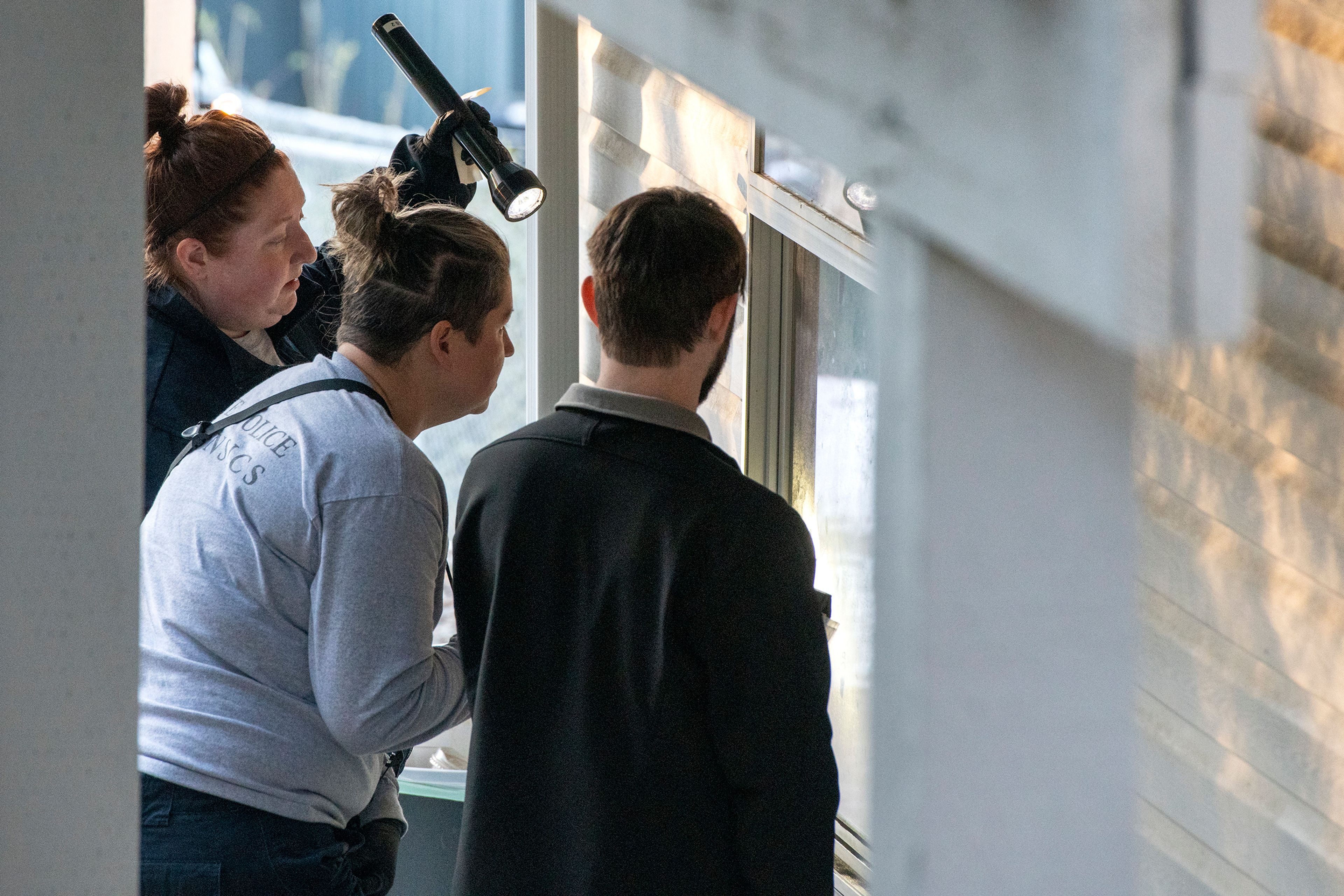 Members of the Idaho State Police forensic team investigate Friday at a home where four University of Idaho students were recently murdered over the weekend in Moscow.