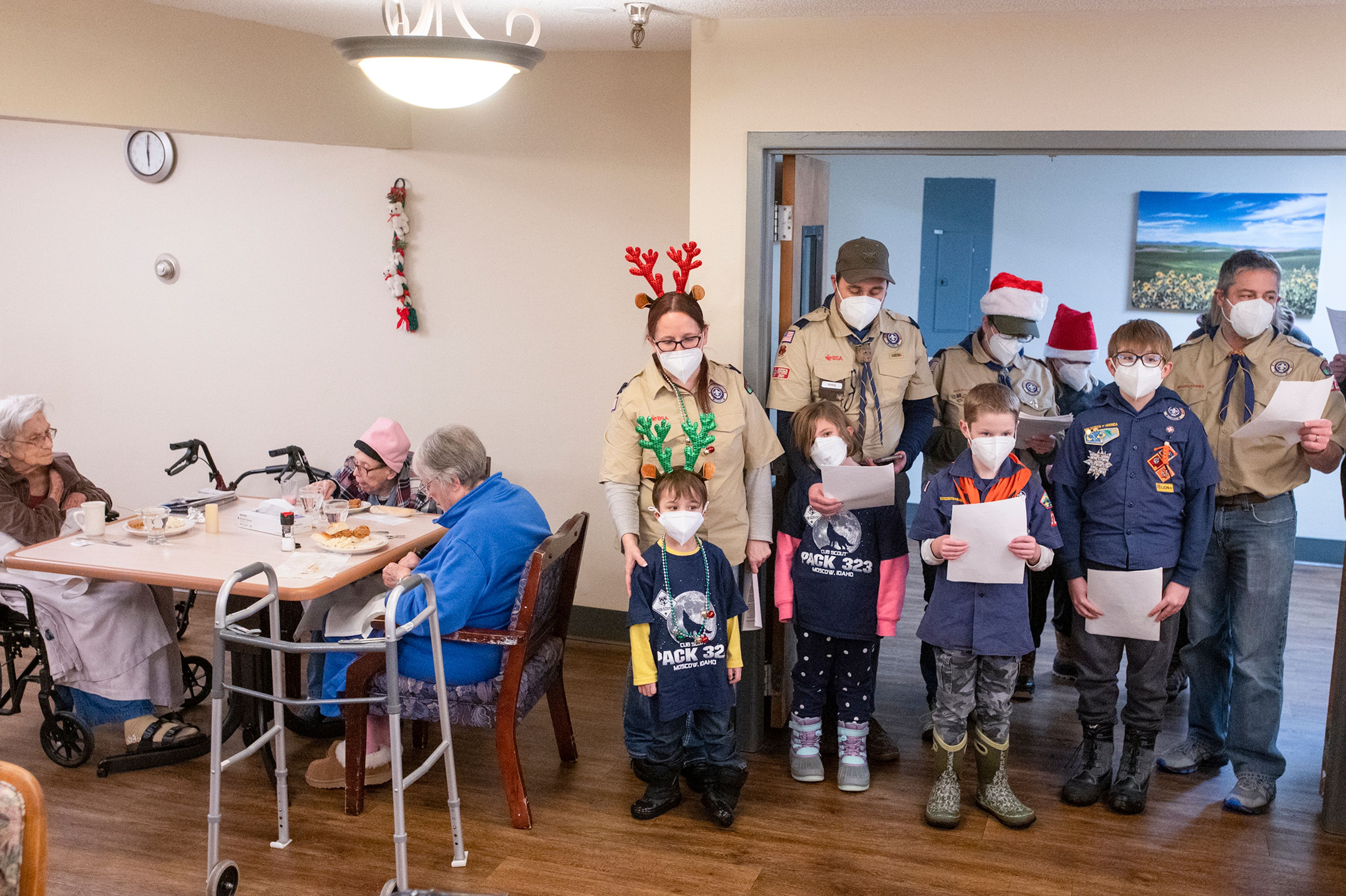 Boy Scout members of Troop 345 and Pack 323 sing Christmas carols for residents in the dining hall at Aspen Park of Cascadia in Moscow on Wednesday.