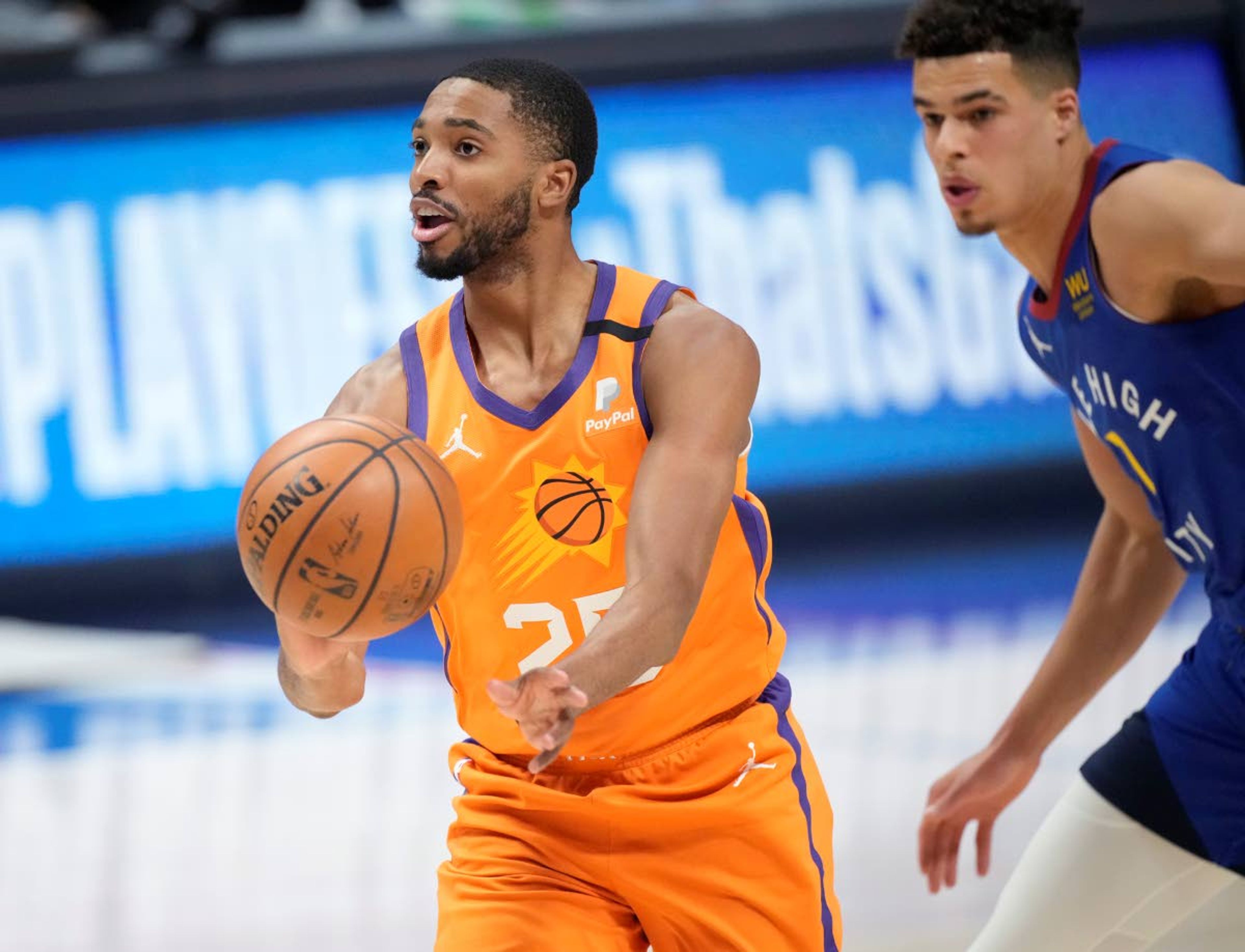 Phoenix Suns forward Mikal Bridges, left, drives past Denver Nuggets forward Michael Porter Jr. in the first half of Game 3 of an NBA second-round playoff series Friday, June 11, 2021, in Denver. (AP Photo/David Zalubowski)