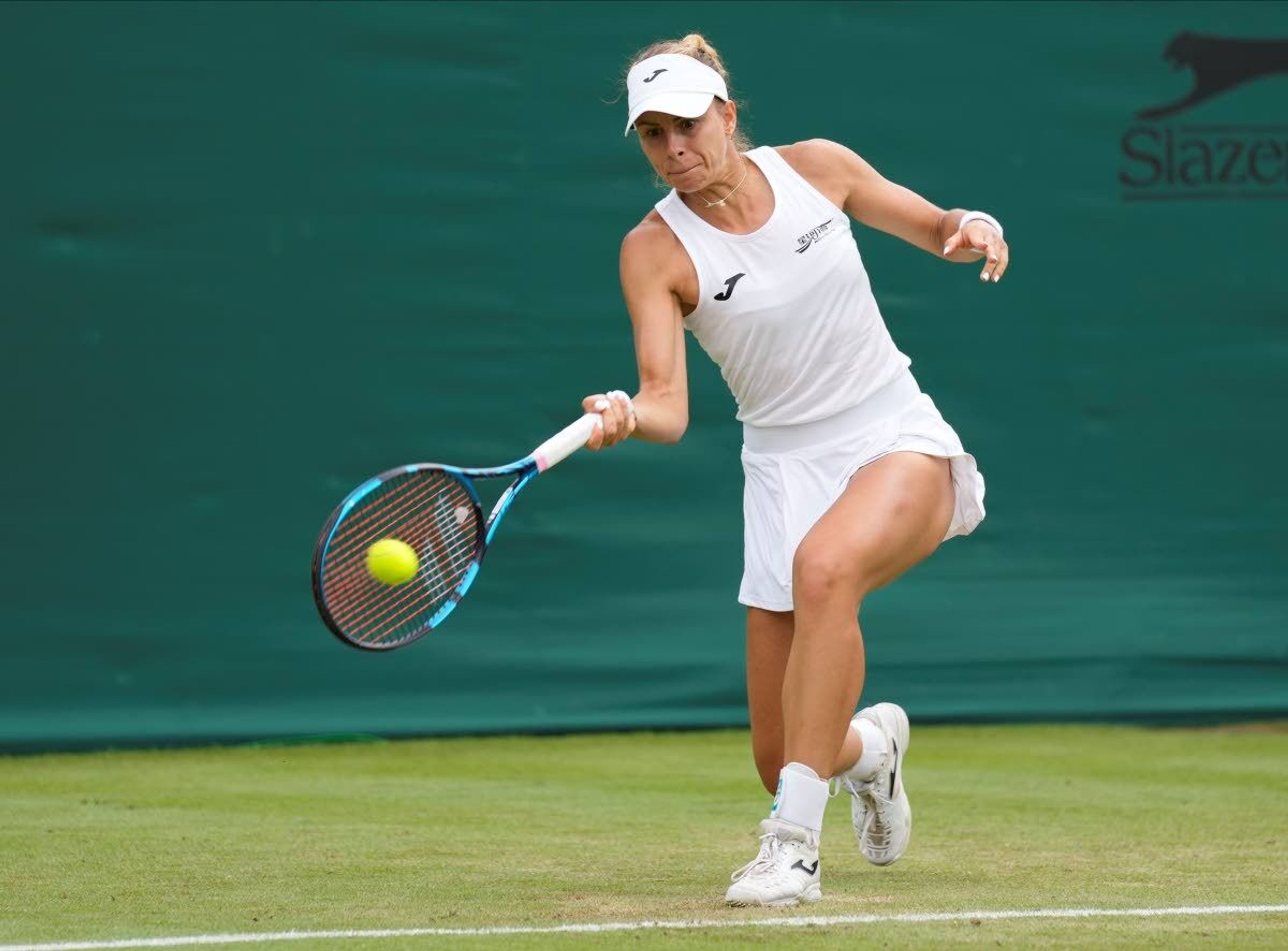 Poland's Magda Linette plays a return to Ukraine's Elina Svitolina during the women's singles second round match on day four of the Wimbledon Tennis Championships in London, Thursday July 1, 2021. (AP Photo/Kirsty Wigglesworth)