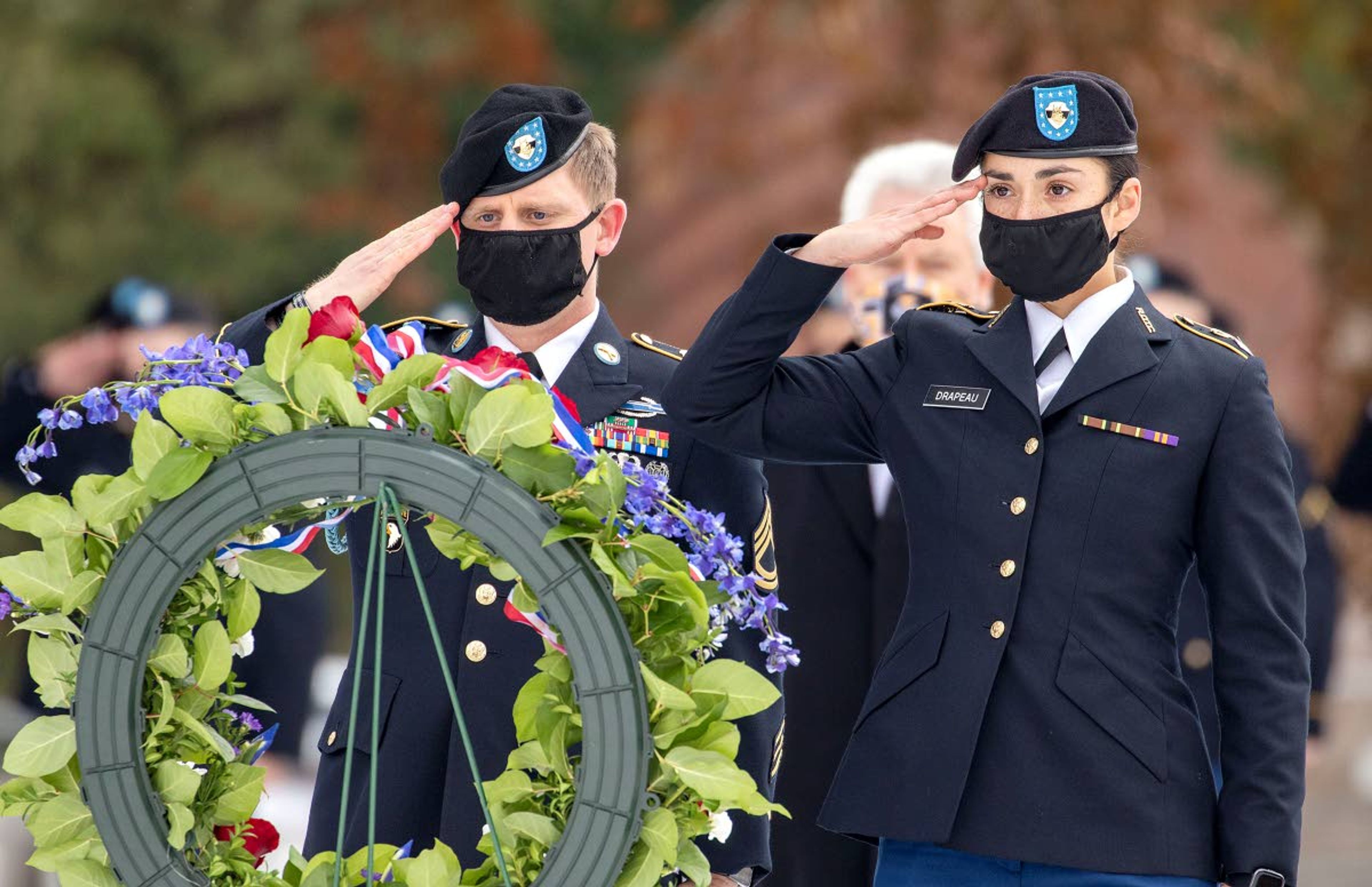 LEFT: Army ROTC cadet Nathan Eisenhower plays taps during a University of Idaho Veterans Day ceremony Wednesday in Moscow.BELOW: Army ROTC cadets Eric Peterson, left, and Anna Drapeau salute a memorial wreath after placing it on a stand during a University of Idaho Veterans Day ceremony Wednesday in Moscow.