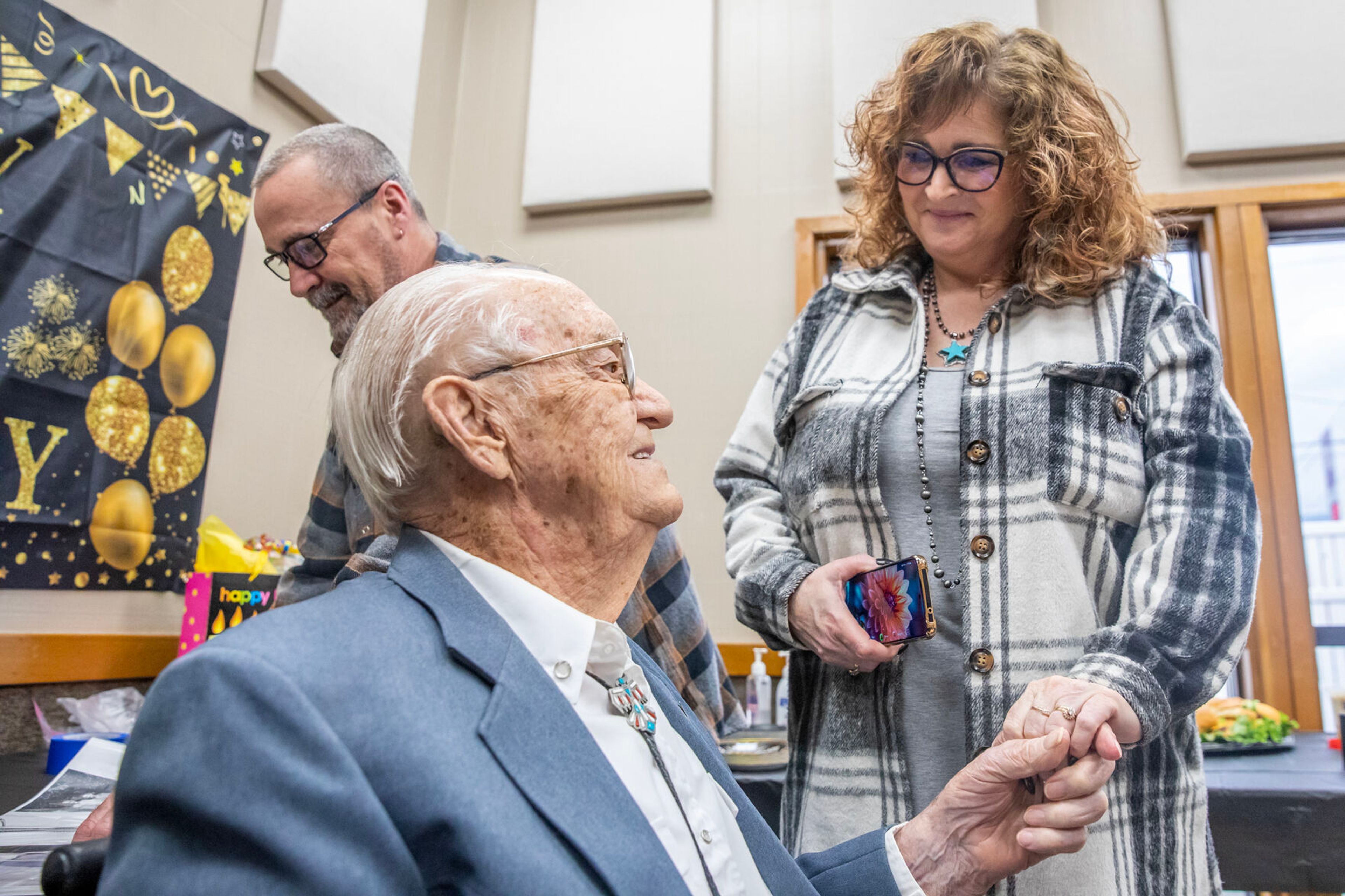 Floyd Thomason clasps hands with Diann Geagley, wife of his grandson Brad Geagley Saturday at the Lewiston Community Center.