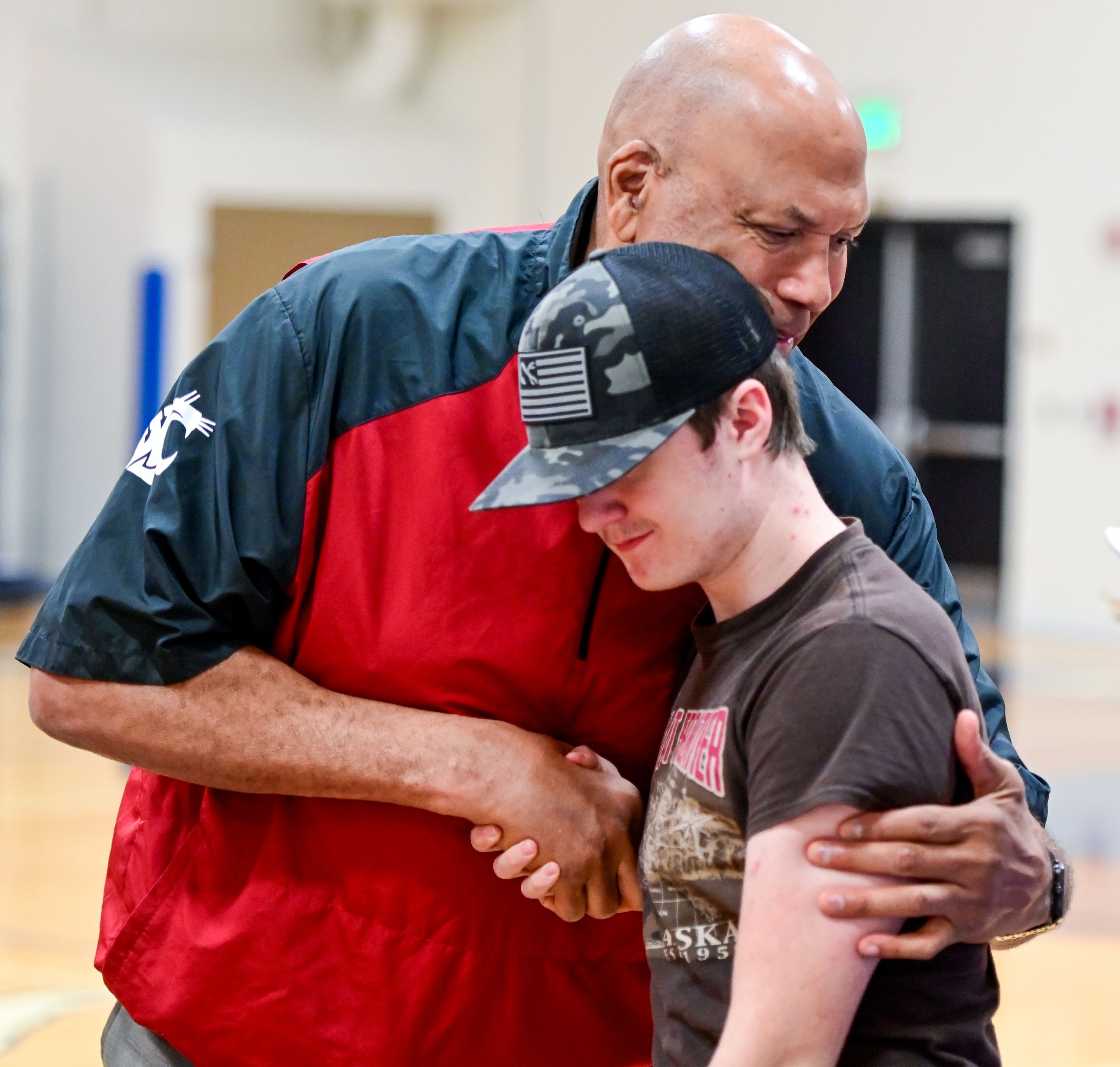 Former NBA and WSU athlete James Donaldson pulls Dakota Cook, a sophomore at Colton High School, into a hug after Donaldson’s talk about mental health with students on Tuesday.